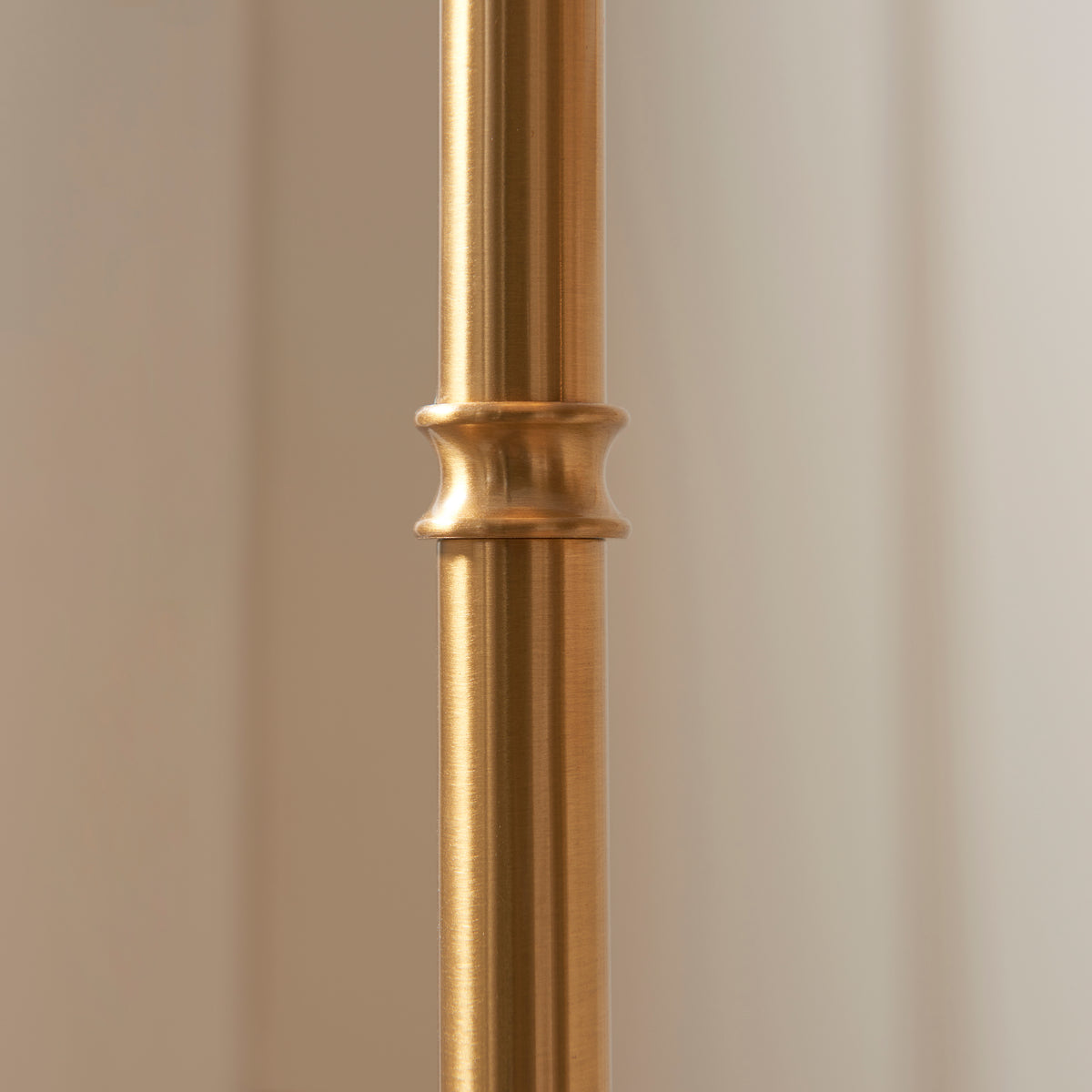 Close up of the turned collar detail on the brushed aged brass stem of the Endon Burley rechargeable floor lamp