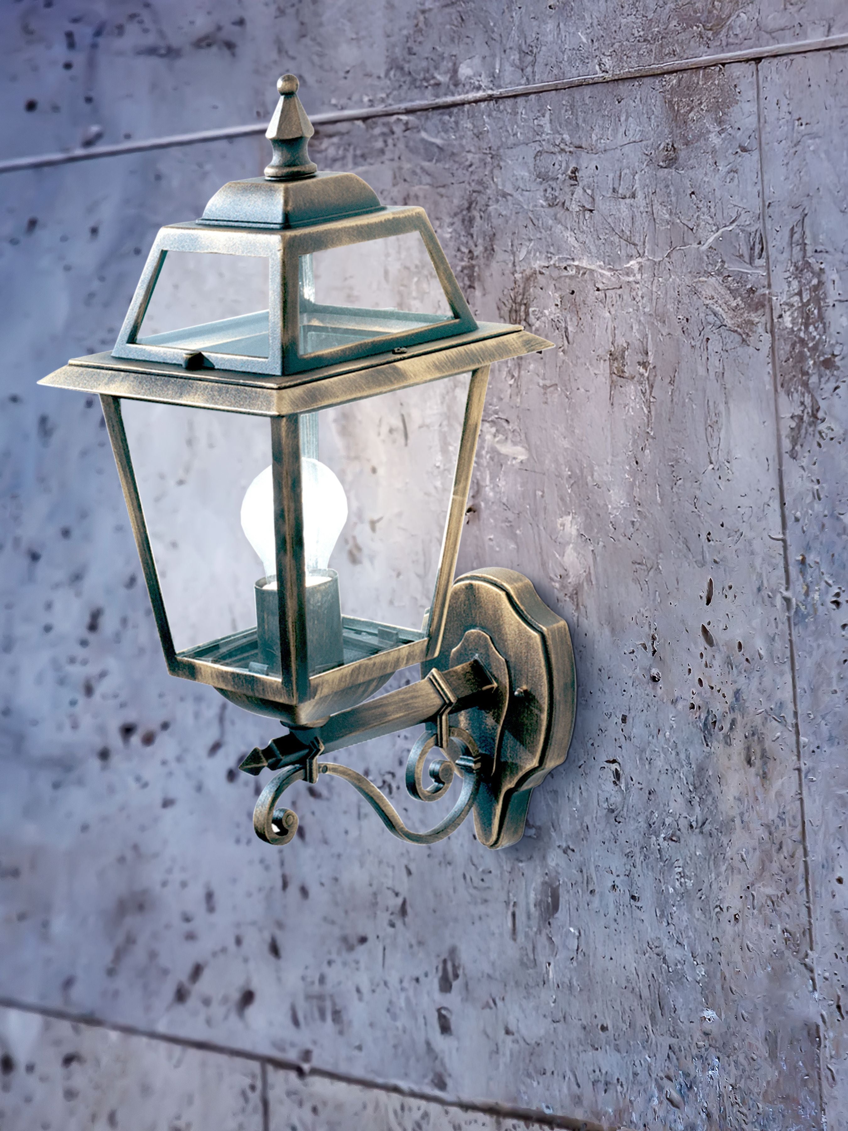 New Orleans outdoor wall uplighter installed and lit on a stone wall