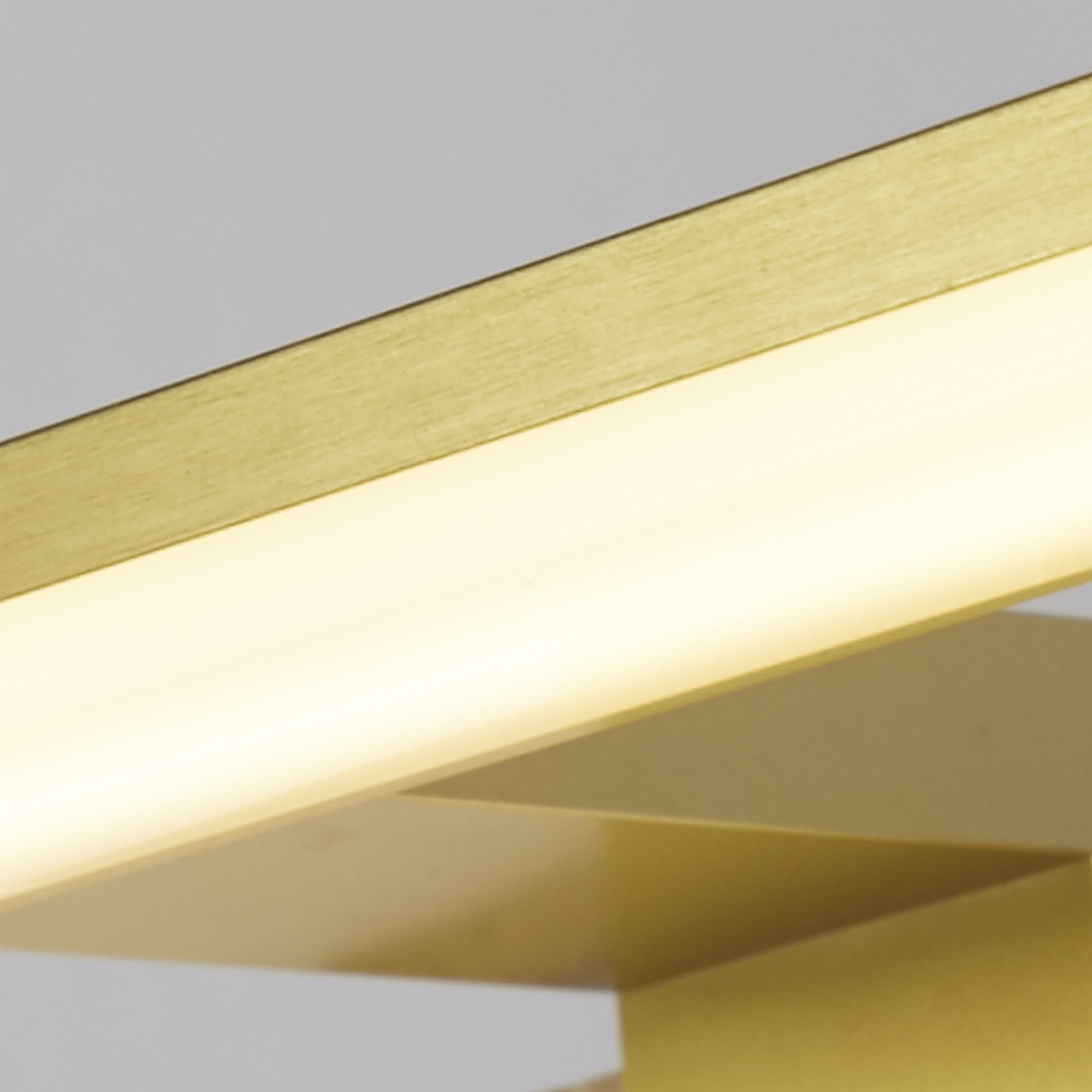 Close up of the Kos matt gold bar showing the brushed metal finish and illuminated LED strip