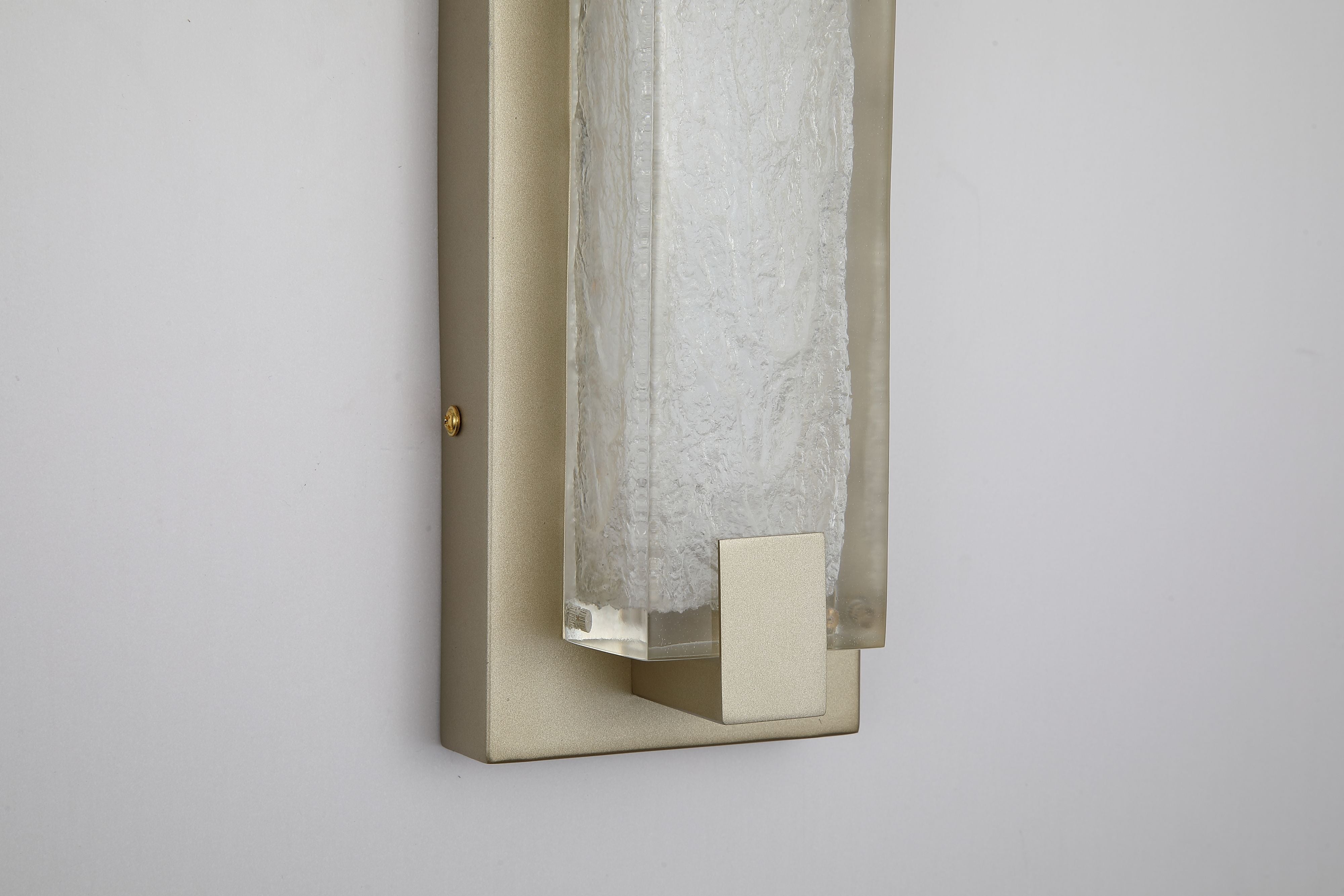 Close up of the Searchlight Anchor LED wall light showing the gold end cap and the rippled icicle texture of the polycarbonate panel