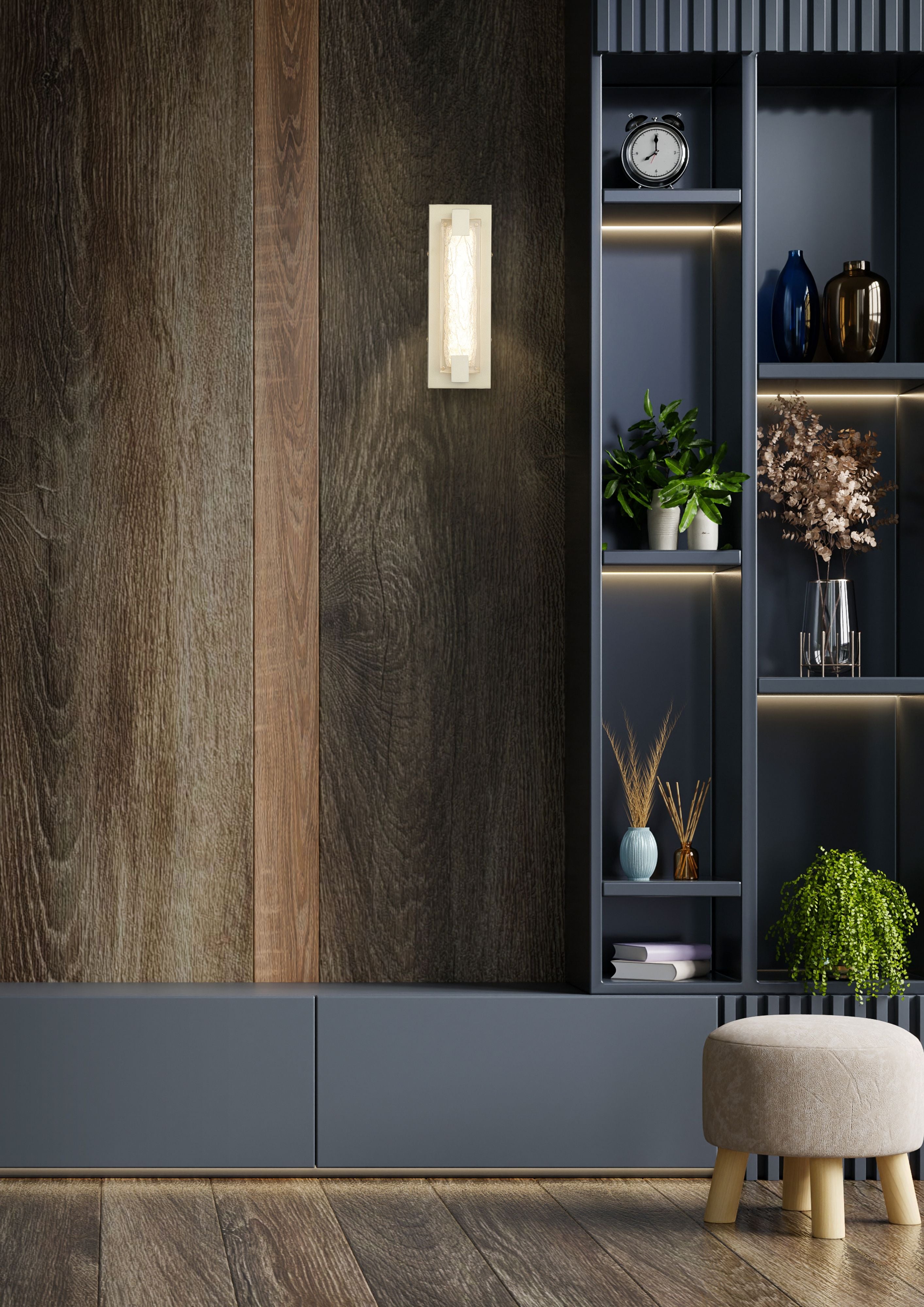 Searchlight Anchor LED wall light in gold mounted on a dark wood panelled wall beside a grey shelving unit styled with plants and decor