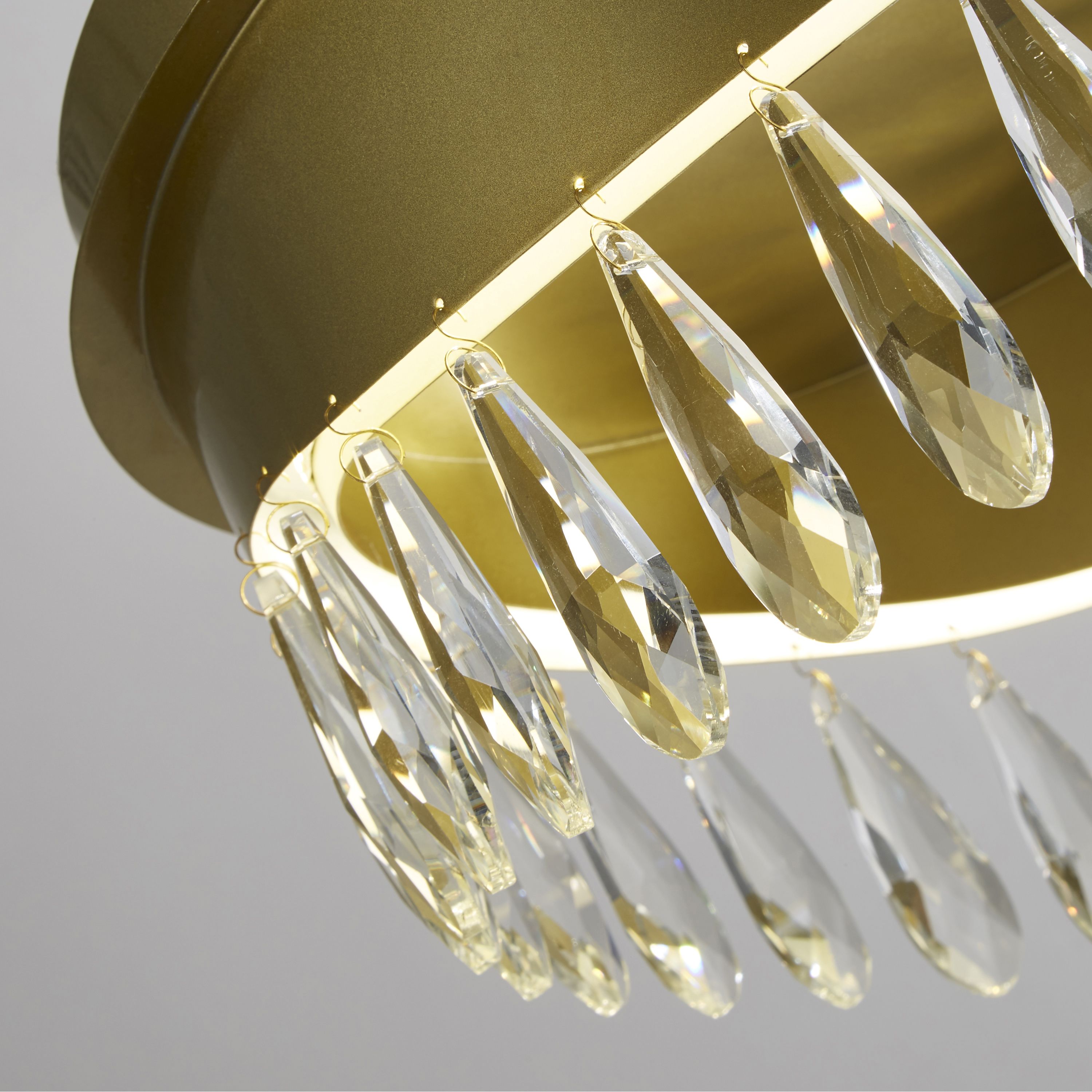 Close up of the crystal pear drops and gold rim detail on the Jewel flush ceiling light