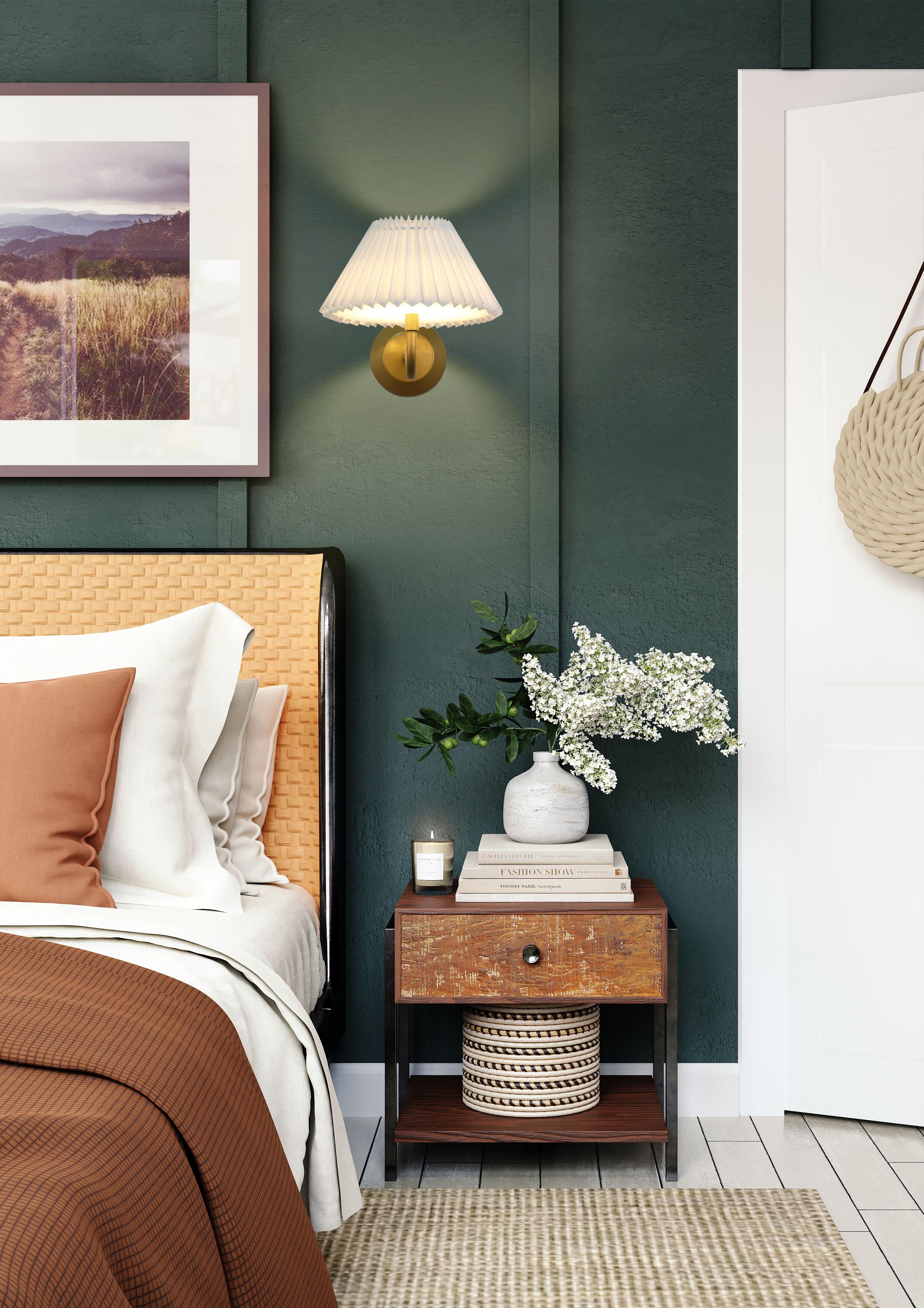 Danish rechargeable wall light in gold with white pleated shade mounted above a bedside table in a dark green bedroom