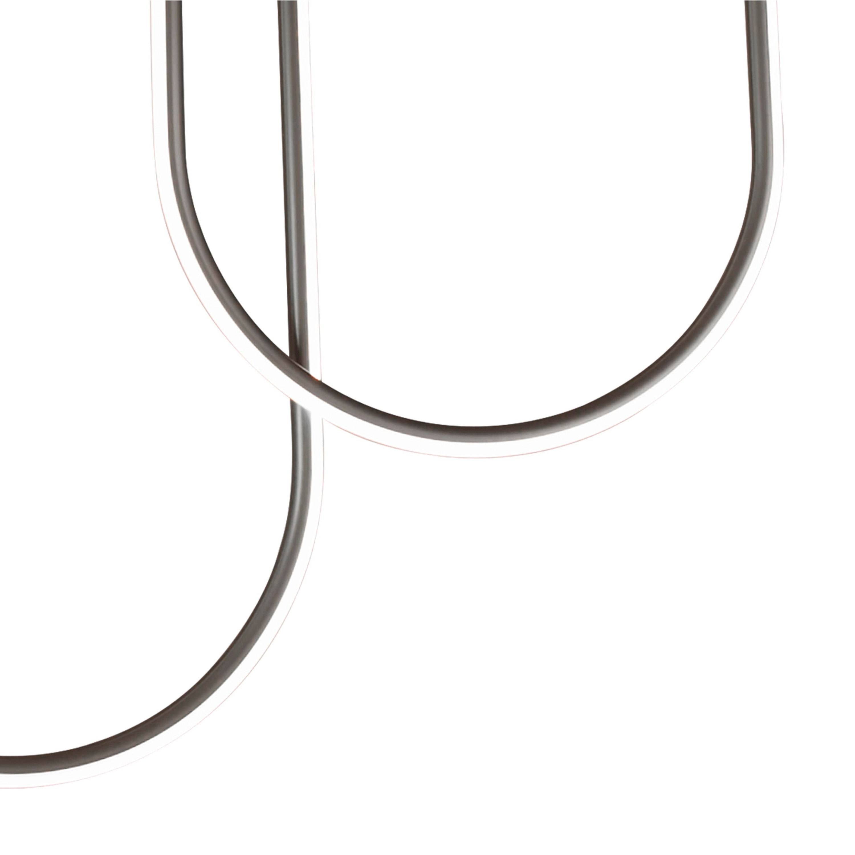 Close up of two of the Chime LED flush light's opal tubes crossing, showing the matt black join detail