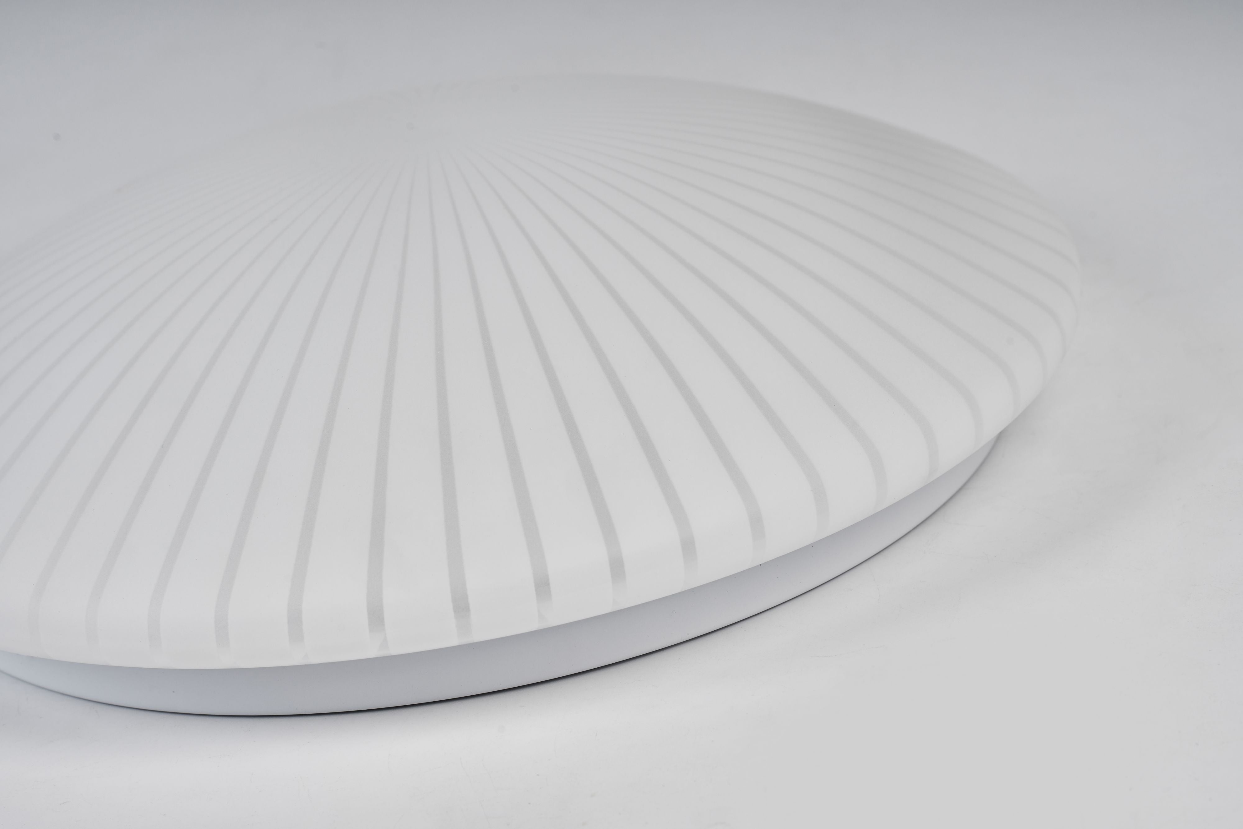 Close up angled view of the Malta flush ceiling light dome, showing the fine pleated ridge pattern moulded into the acrylic shade