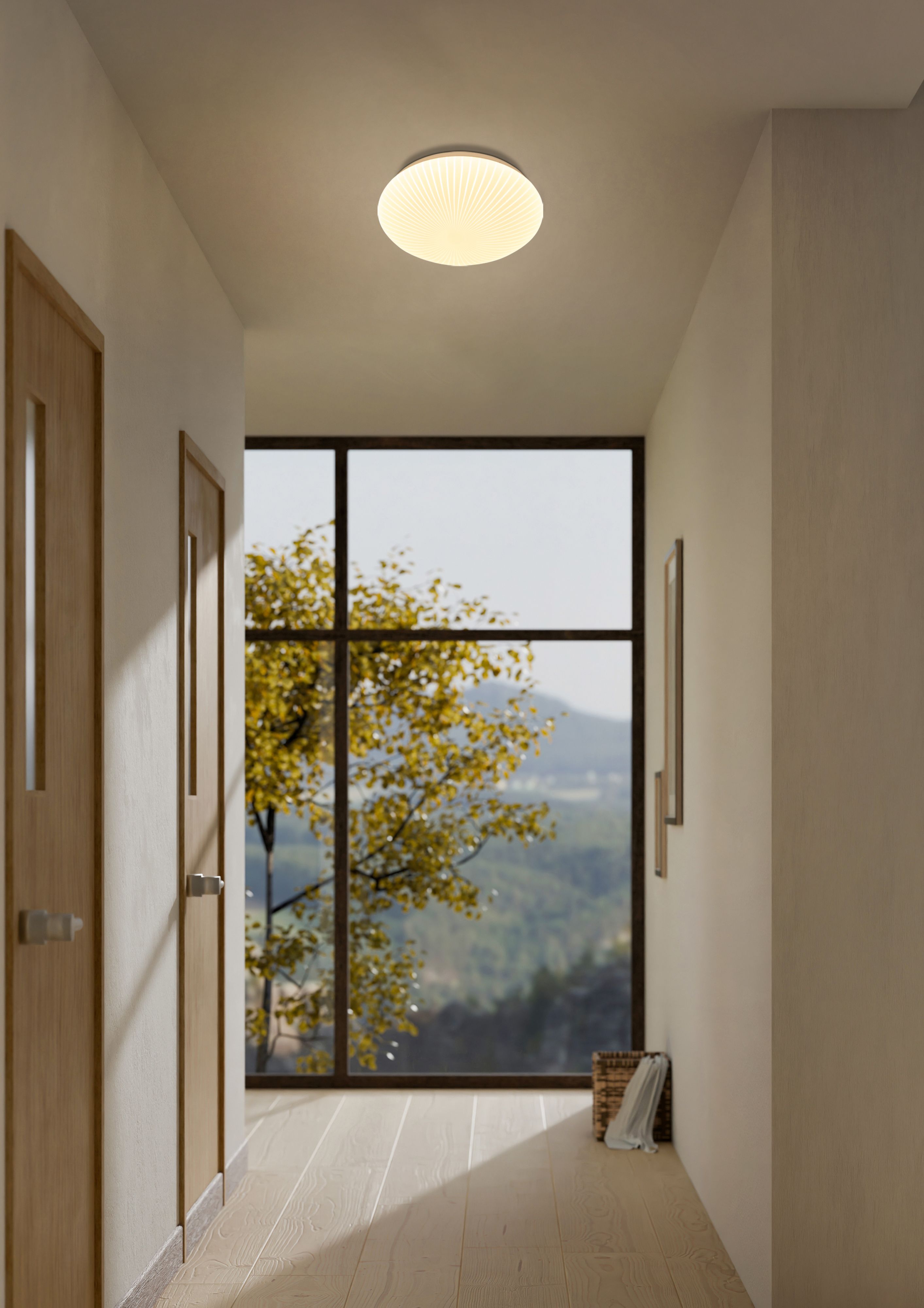 Searchlight Malta LED flush ceiling light in white acrylic, styled on the ceiling of a hallway with a large window and view of trees outside