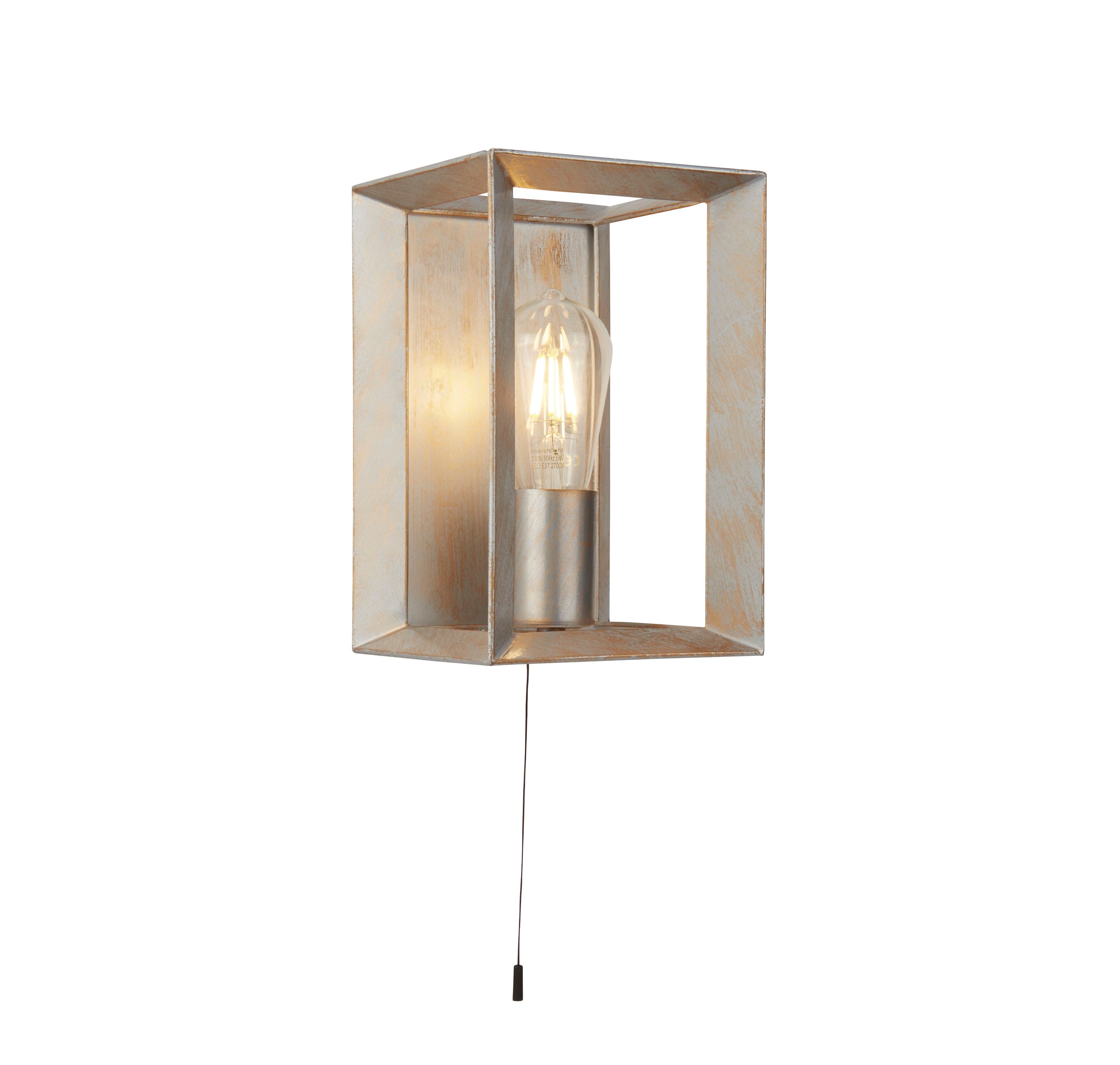 Searchlight Heaton Wall Light in brushed gold and silver metal, front view of the open box cage with a lit filament bulb and pull cord switch, on a plain studio background