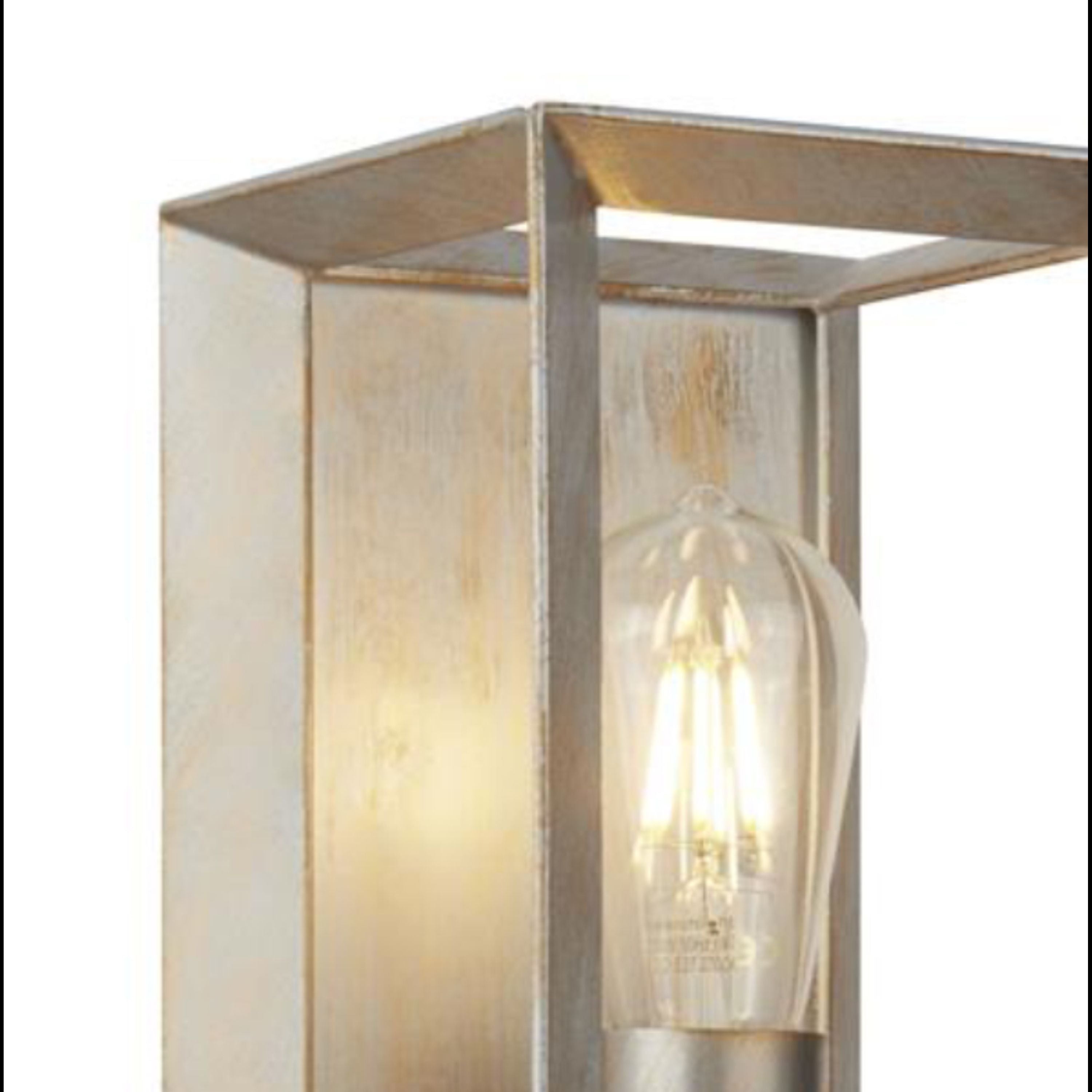 Close up of the Searchlight Heaton wall light's lamp holder and LED filament bulb, showing the brushed gold and silver patina finish