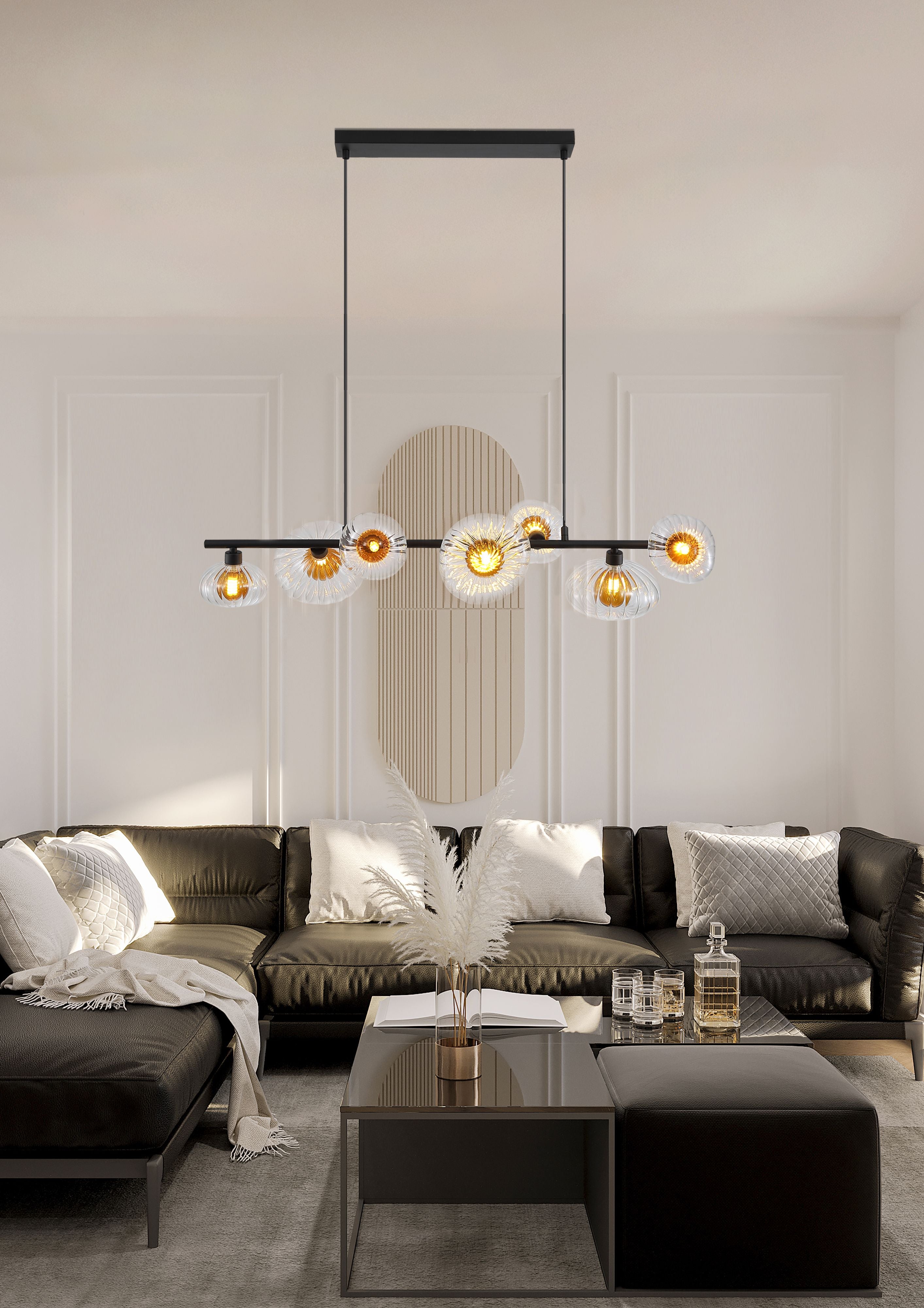 Searchlight Sunbeam 7 light pendant hung above a coffee table in a living room with a dark sofa, pampas grass and drinks glasses