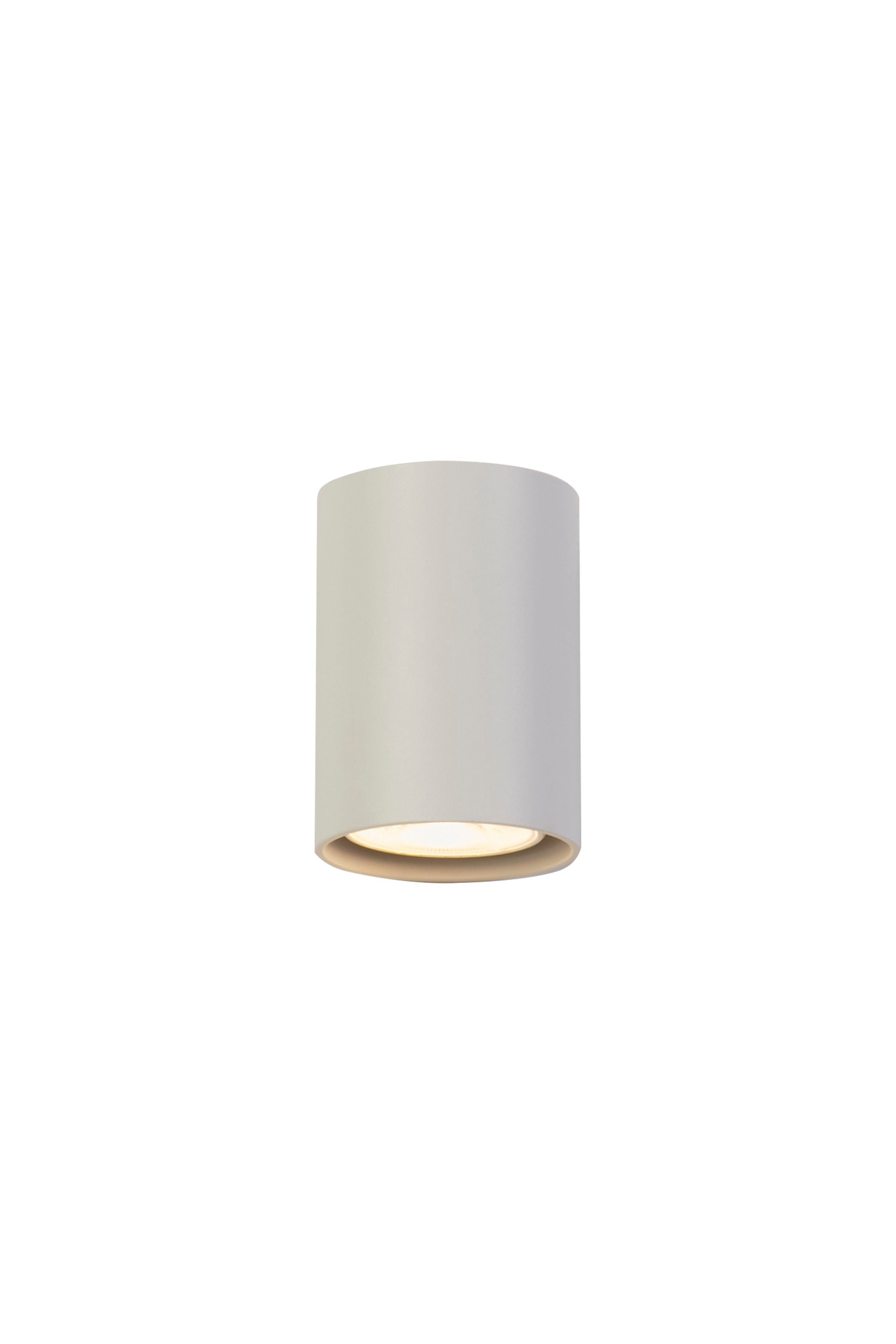 Searchlight Cyls cylinder wall light in white, angled studio shot showing the downward facing aperture lit from below