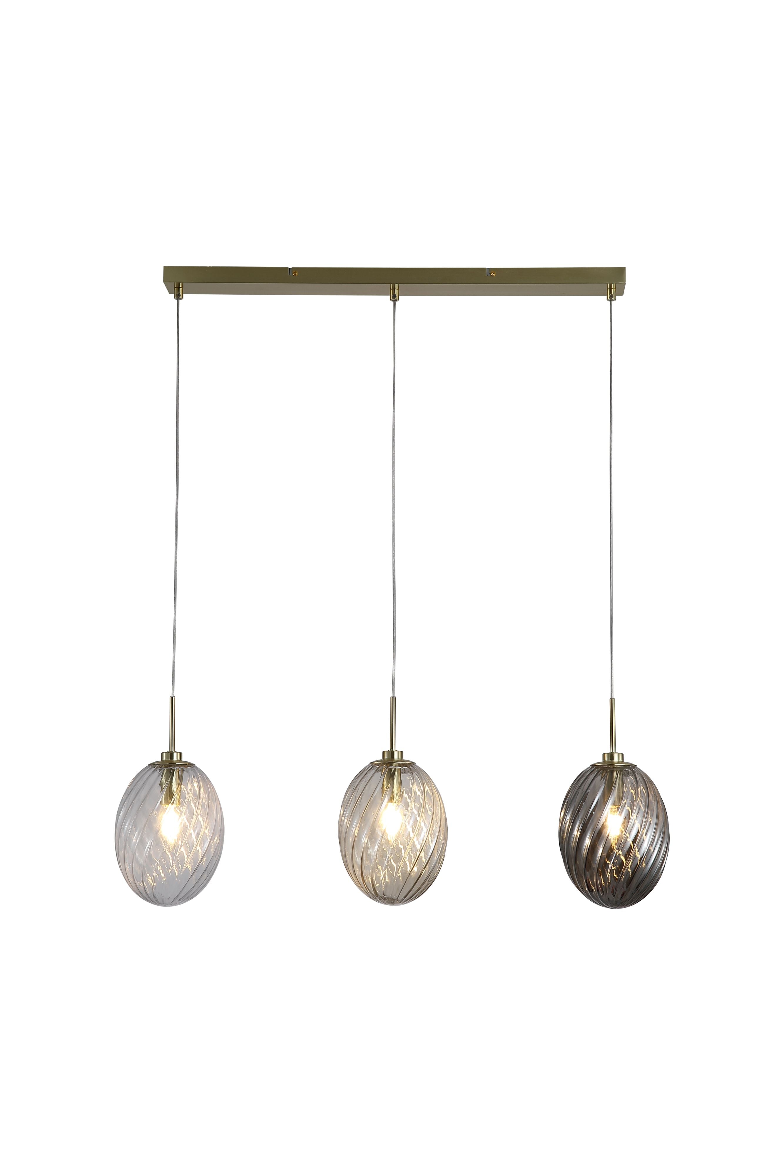 Searchlight Whirl 3 light bar pendant with a satin brass ceiling bar suspending three oval swirled glass shades in clear, champagne and smoked tones, each with a lit bulb, against a plain white background