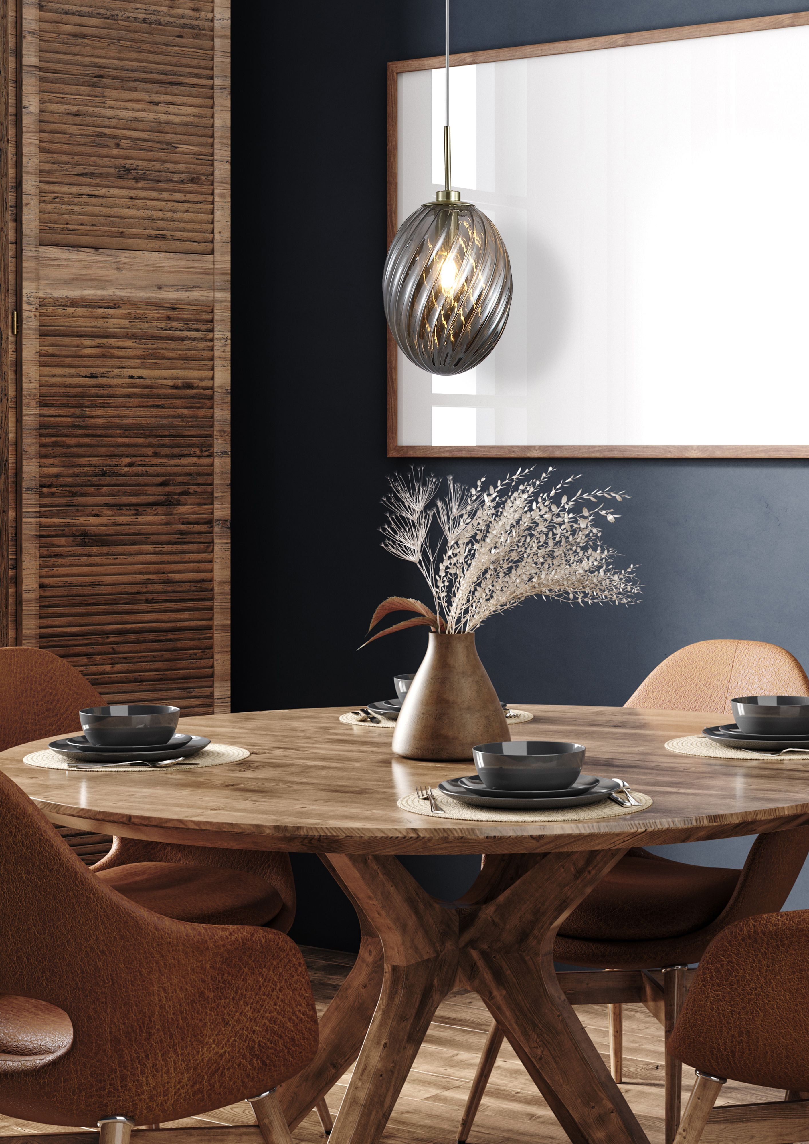 Searchlight Whirl 1 light pendant with smoked glass shade hung above a wooden dining table with tan leather chairs, in front of a slatted wood room divider and dark blue wall
