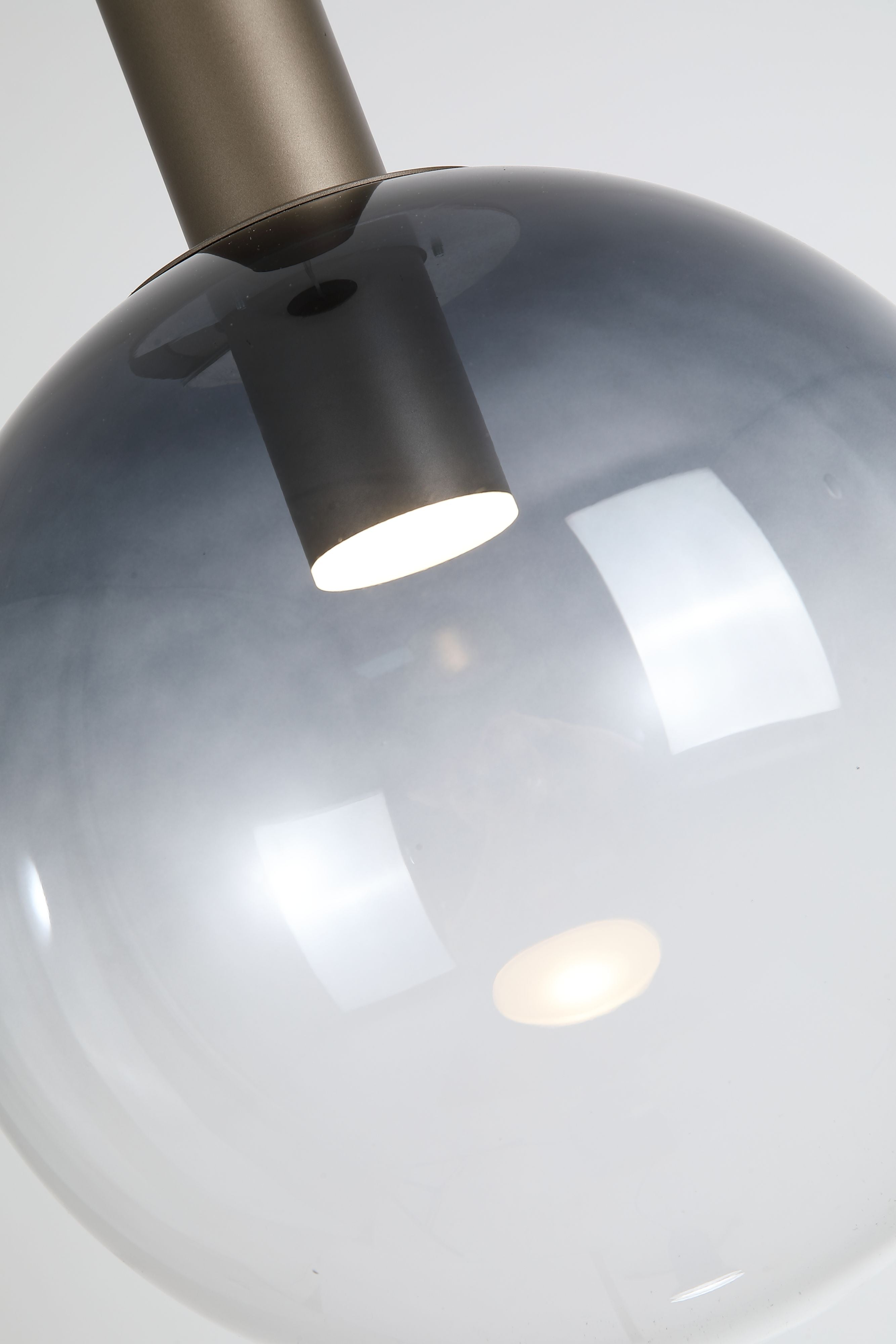 Close up of the GU10 spotlight inside the smoked ombre glass globe, showing the fade to clear glass