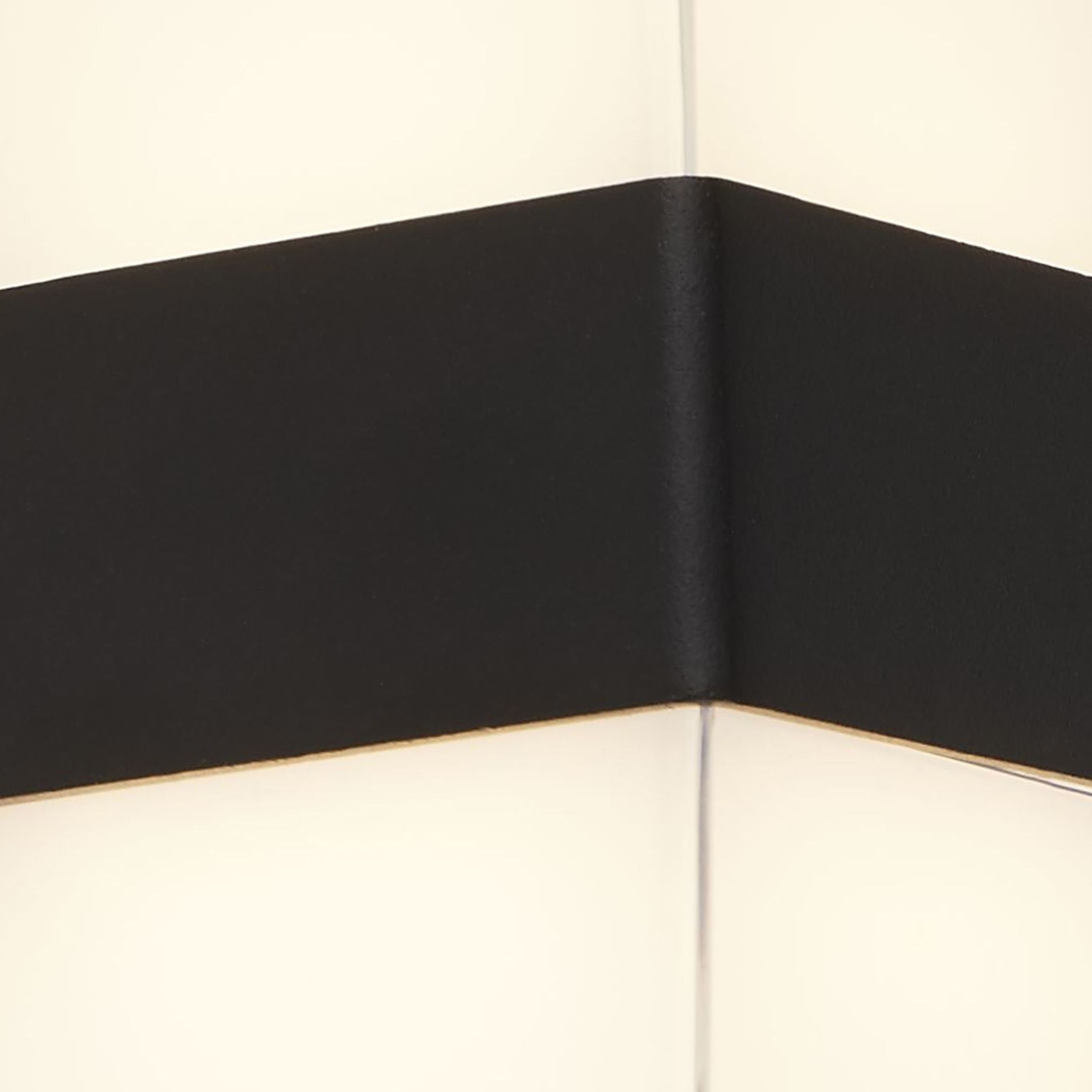 Close up of the Searchlight Pittsburgh square outdoor wall light showing the corner of the black die cast band against the clear polycarbonate cover