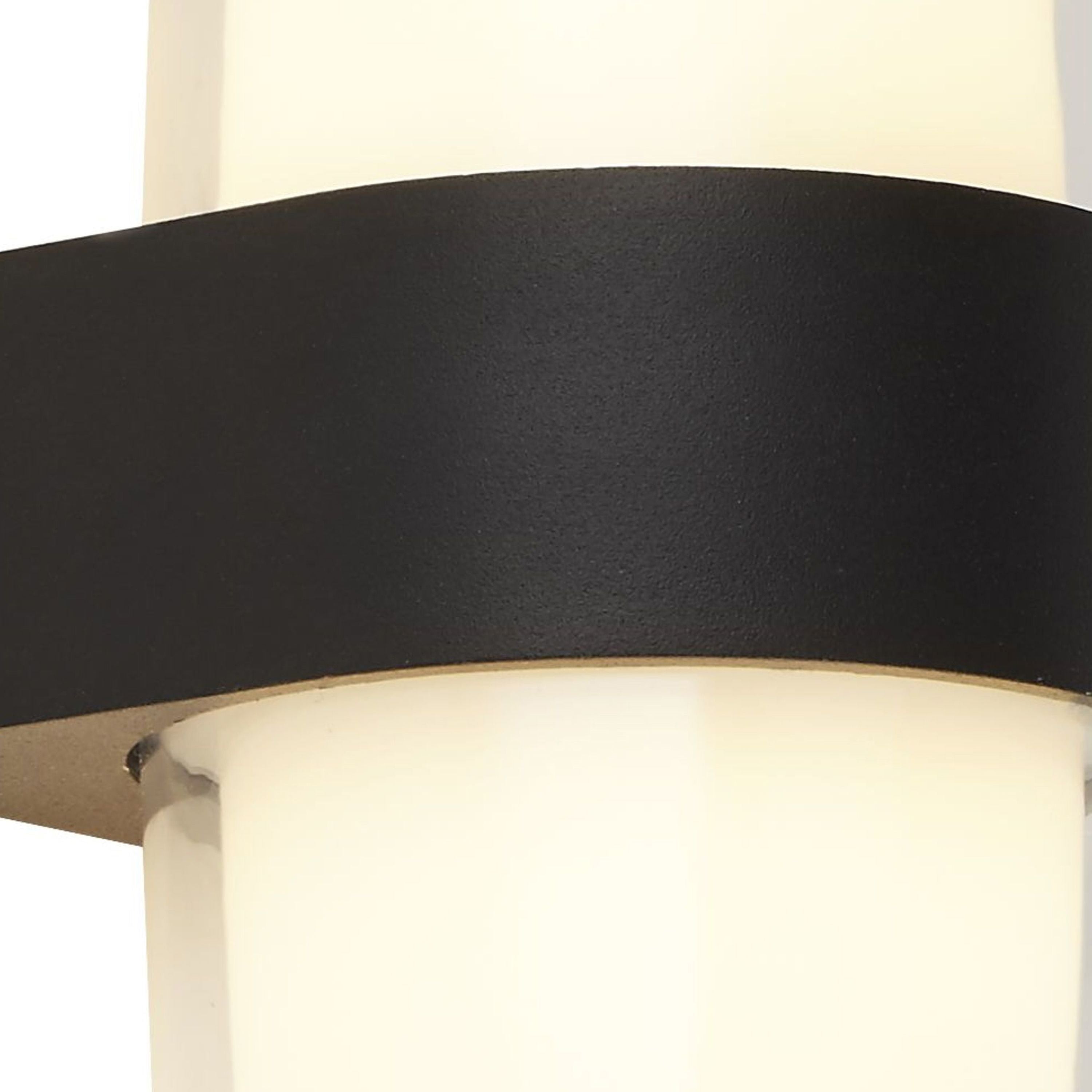 Close up of the Searchlight Pittsburgh round outdoor wall light showing the black die cast band and the warm white glow through the opal panel below it