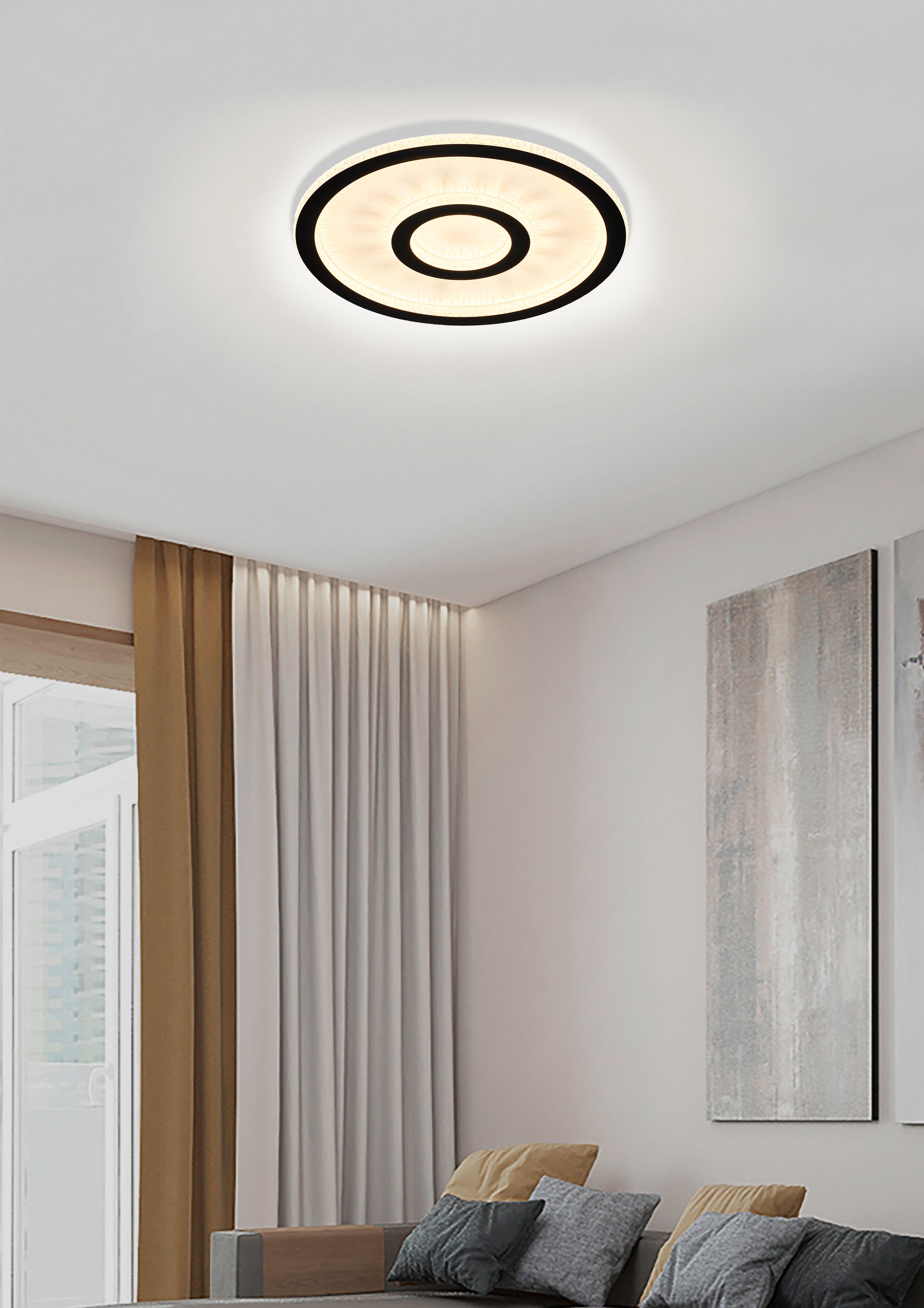 Searchlight Roundel LED flush ceiling light fitted in a styled bedroom with dark accent wall and upholstered bench, glowing warm white