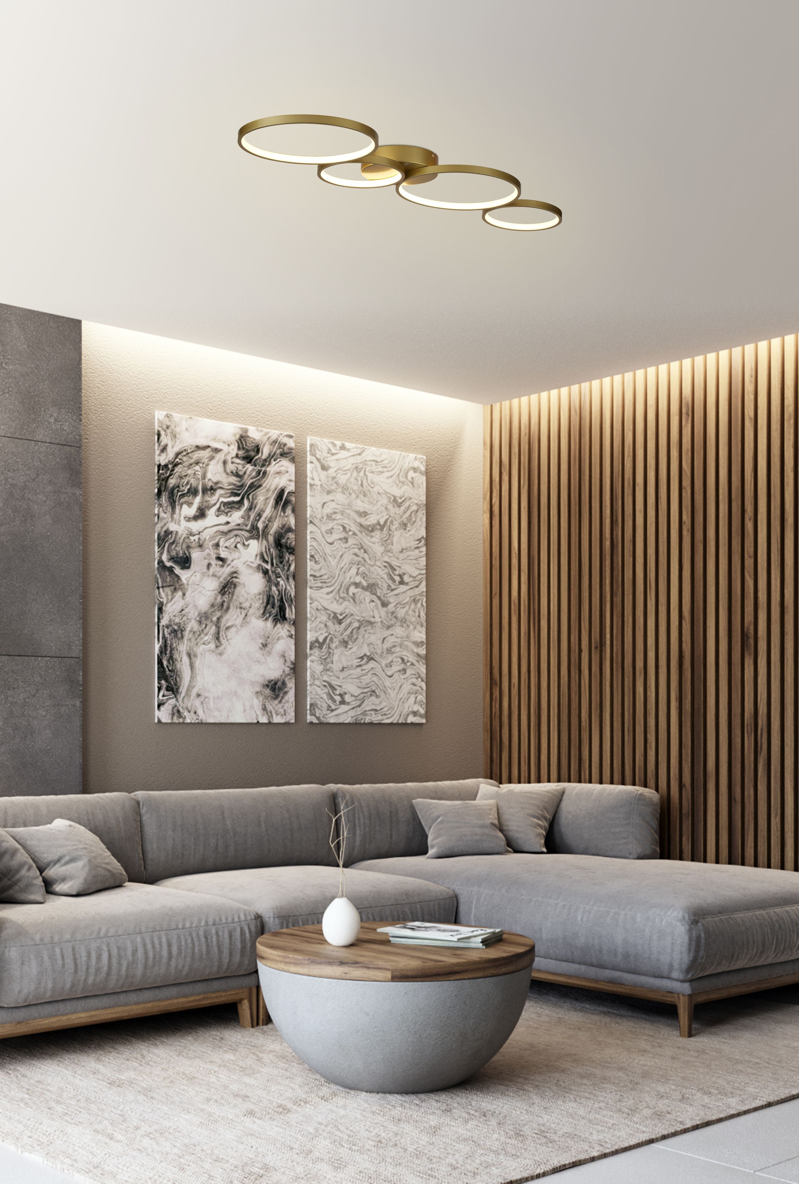 Cirque LED 4 Light Flush in gold styled on a ceiling above a grey sofa, marble style wall art and wood slat panelling in a modern living room