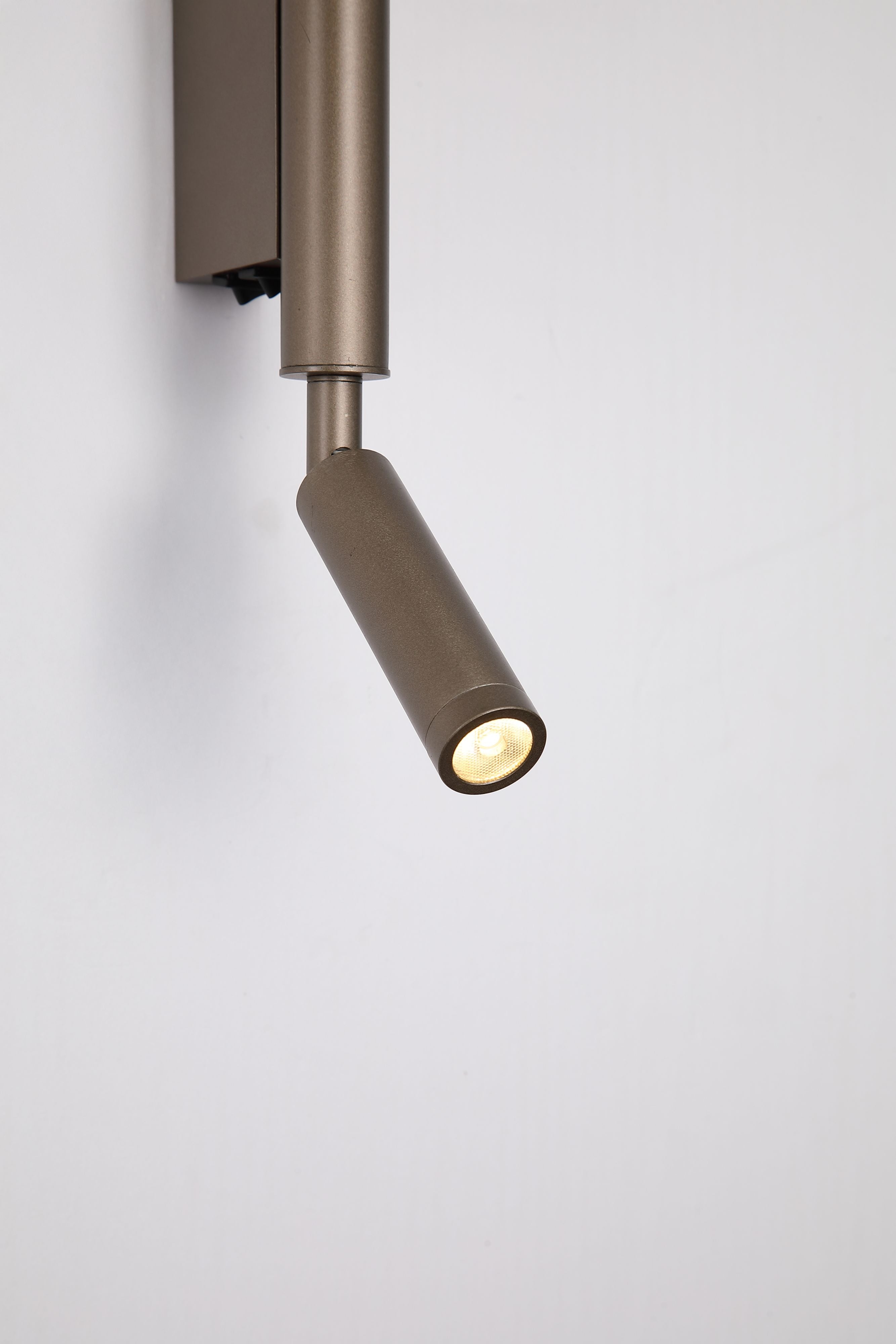 Close up of the Searchlight Architect LED Wall Light with Reading Arm in latte metal, showing the illuminated LED lens and reflector detail on the reading arm