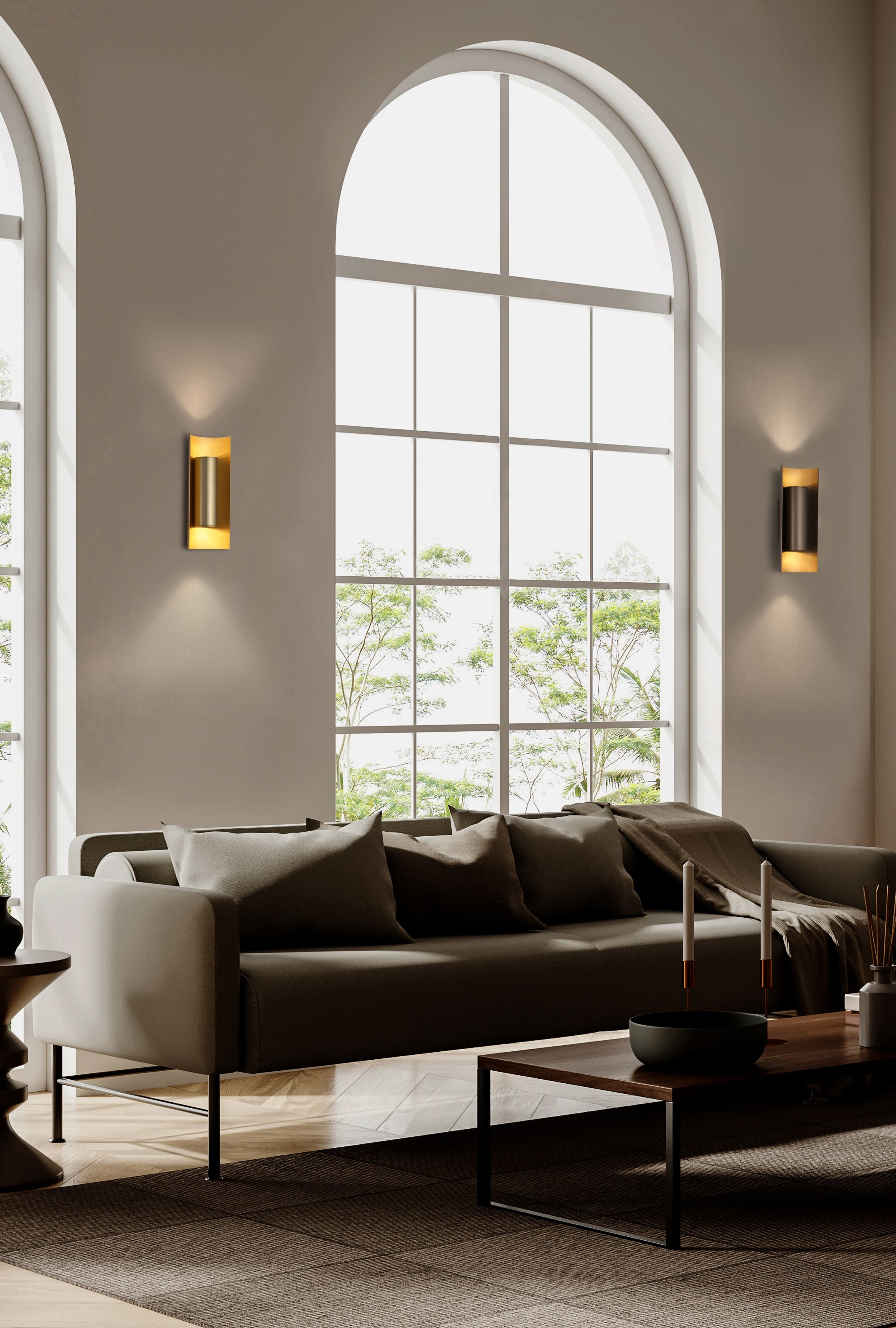 Searchlight Roll 2 Light Wall Light styled in a living room, gold and black finish fixtures mounted either side of a tall arched window above a sofa, casting light up and down the wall