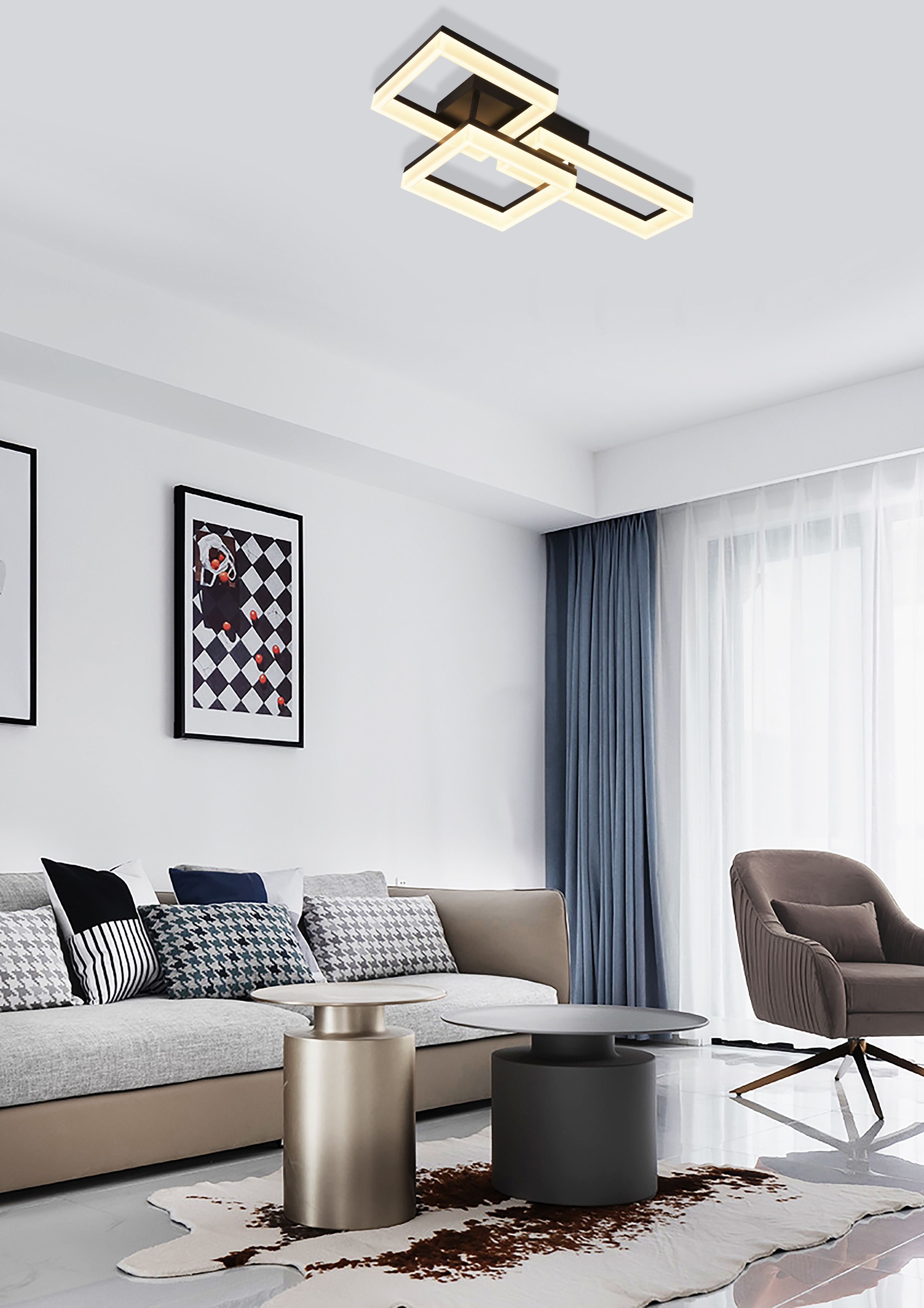 Wall Art II flush ceiling light lit above a living room with a grey corner sofa, patterned cushions and two round side tables