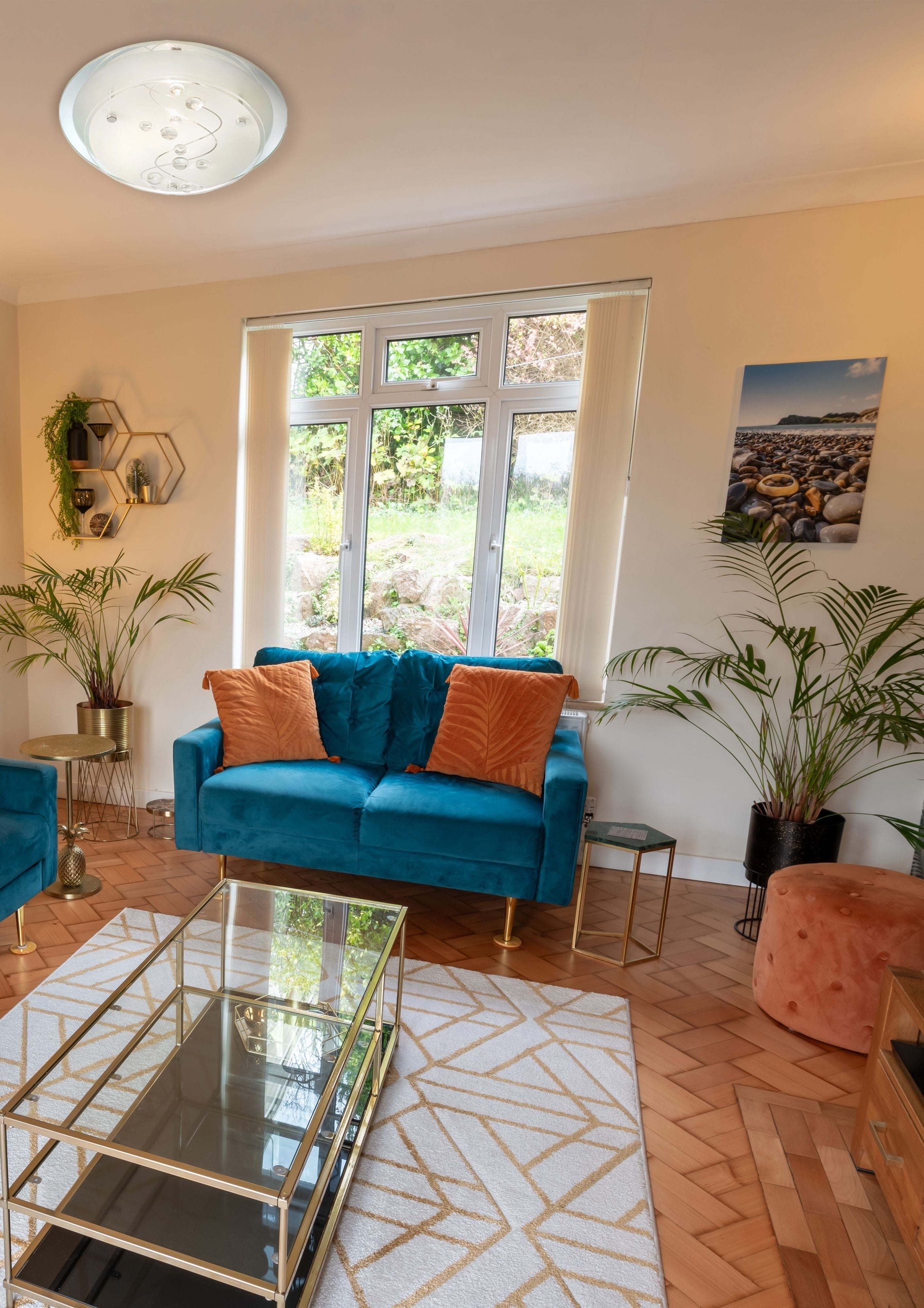 Searchlight Cove flush ceiling light in chrome with glass beads, styled on a living room ceiling above a teal sofa