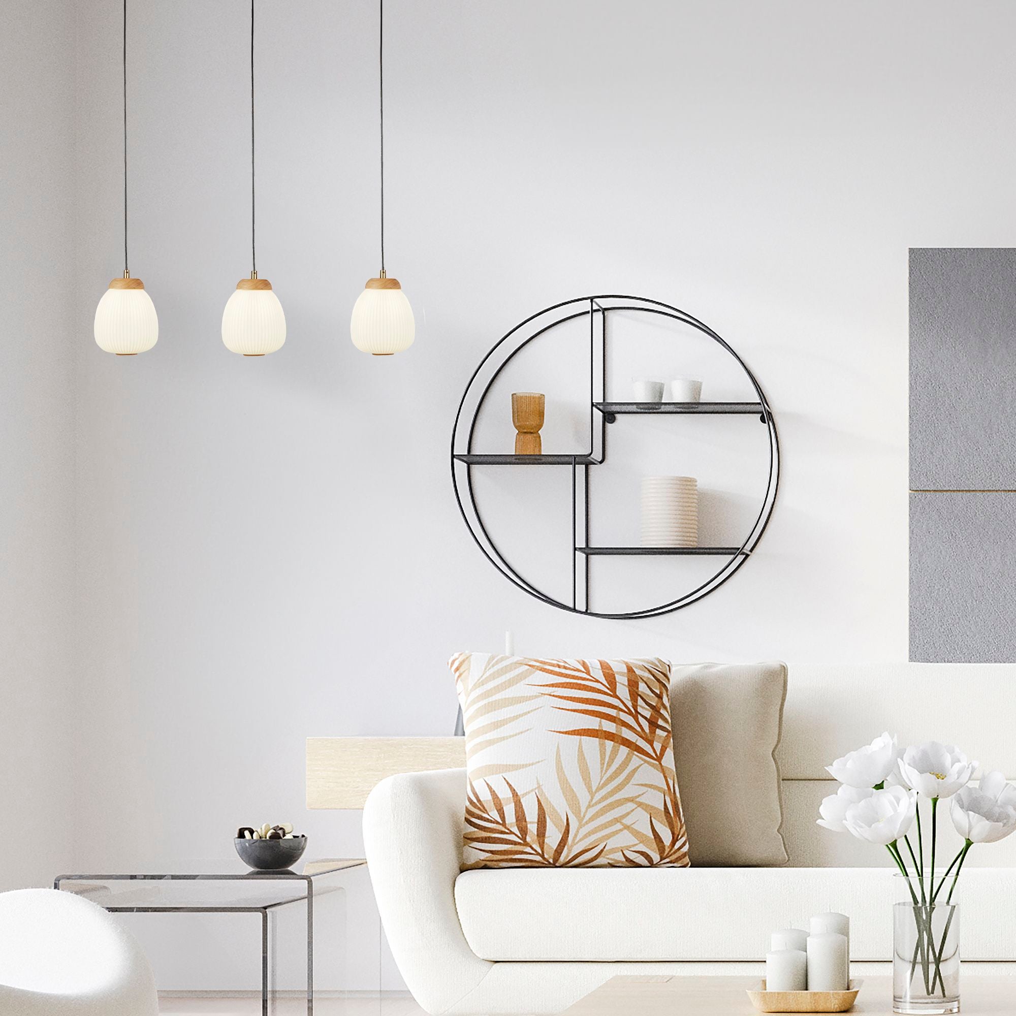 Searchlight Ella 3 Light Pendant styled above a sofa in a living room, next to a round wall shelf