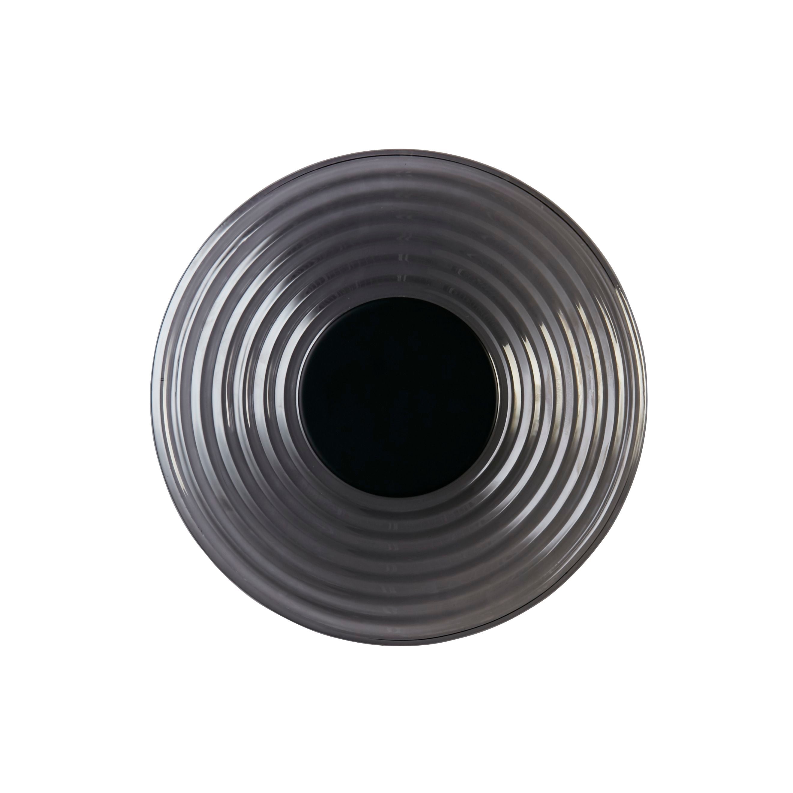 Searchlight Cleo LED wall light in matt black and smoked glass, angled view showing the concentric ridges and matt black centre disc, unlit, on a white studio background