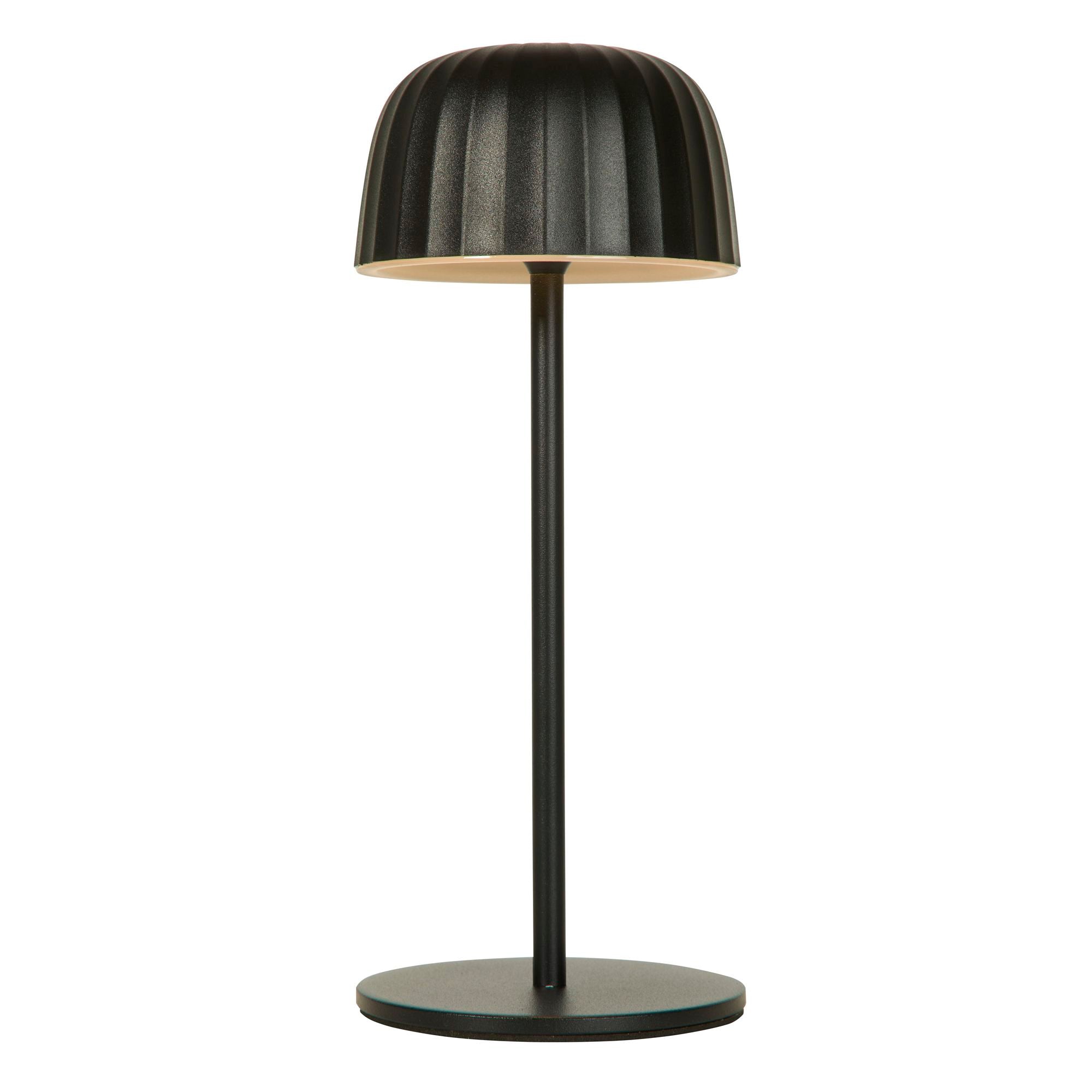 Searchlight Ezra rechargeable table lamp in matt black steel, front view on a white background with the ribbed dome shade lit