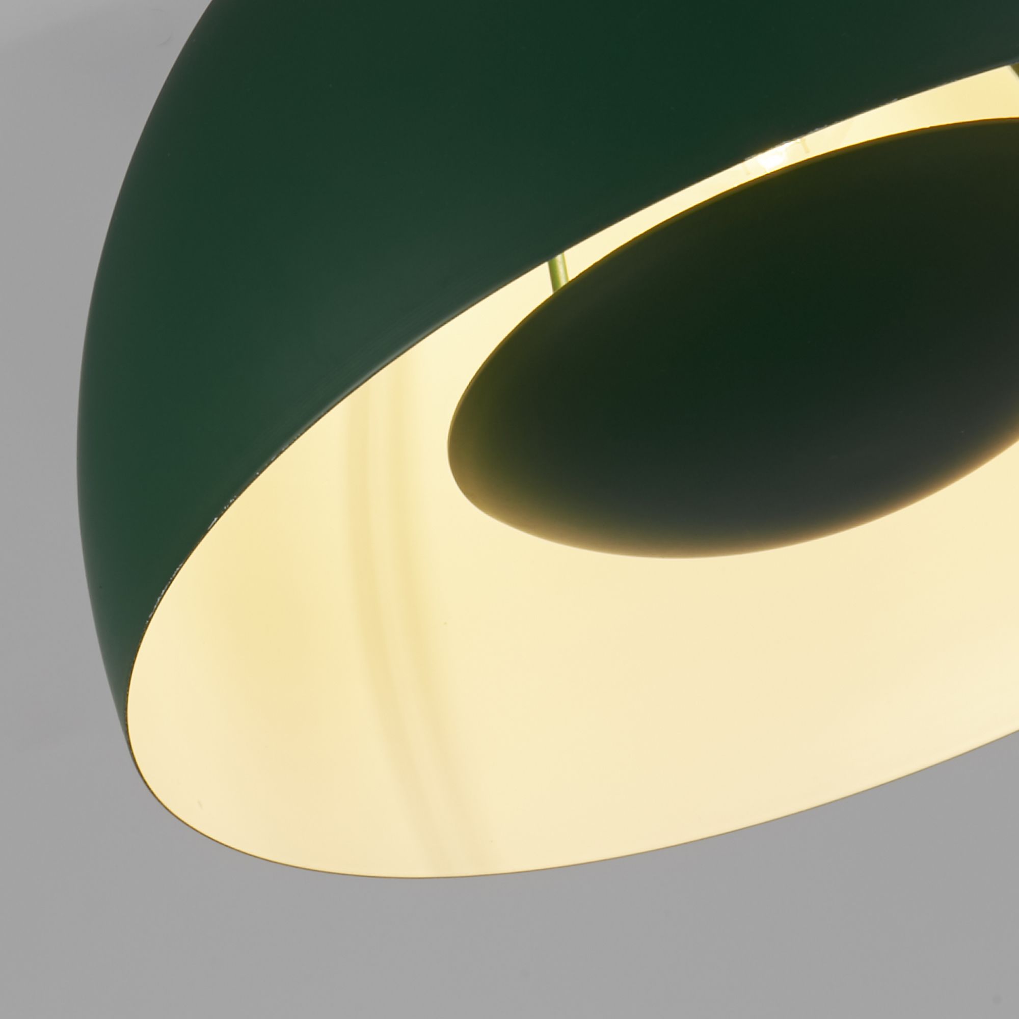 Close up inside the matt green Mars pendant shade, showing the cream interior and lamp holder