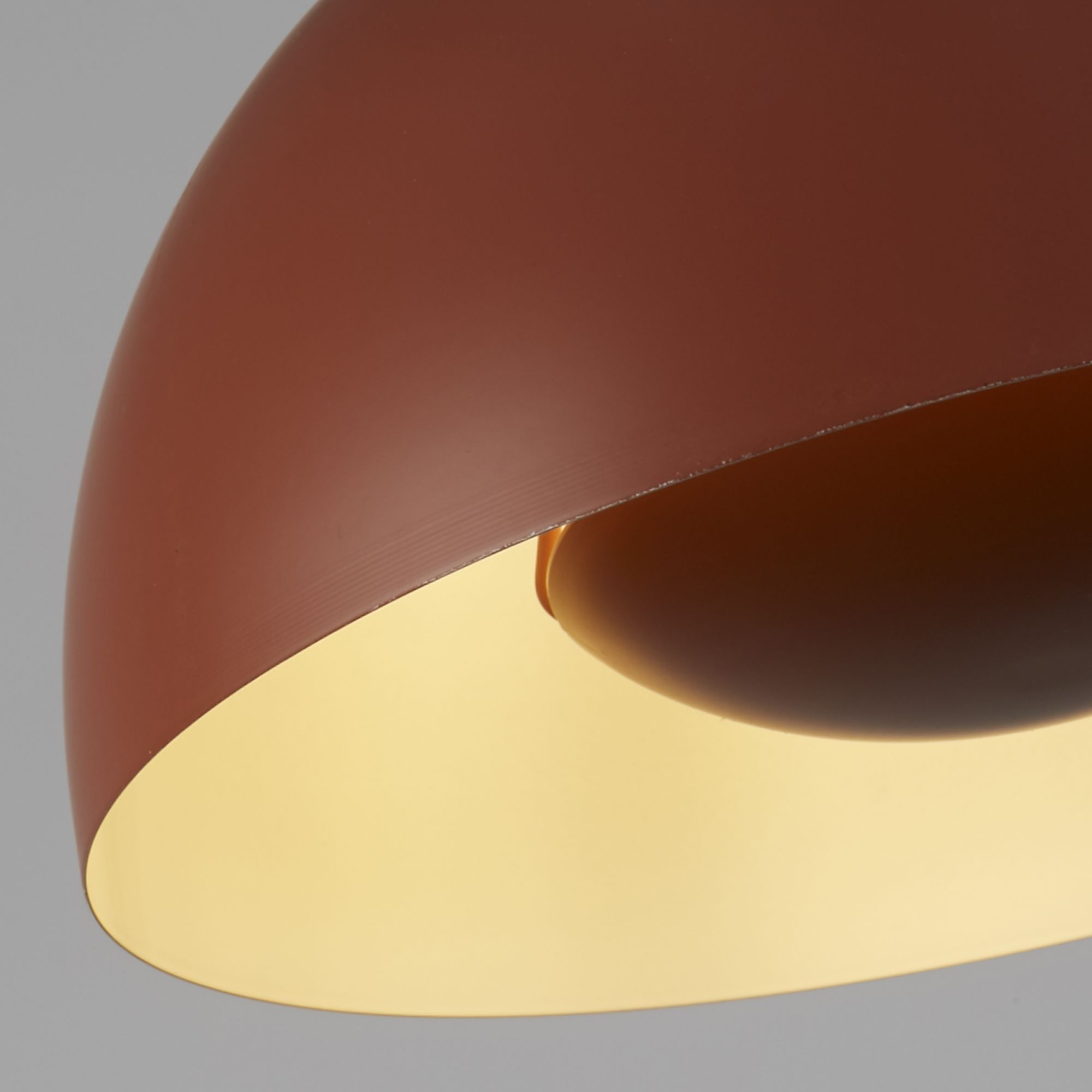 Close up inside the burnt orange Mars pendant shade, showing the cream interior and lamp holder