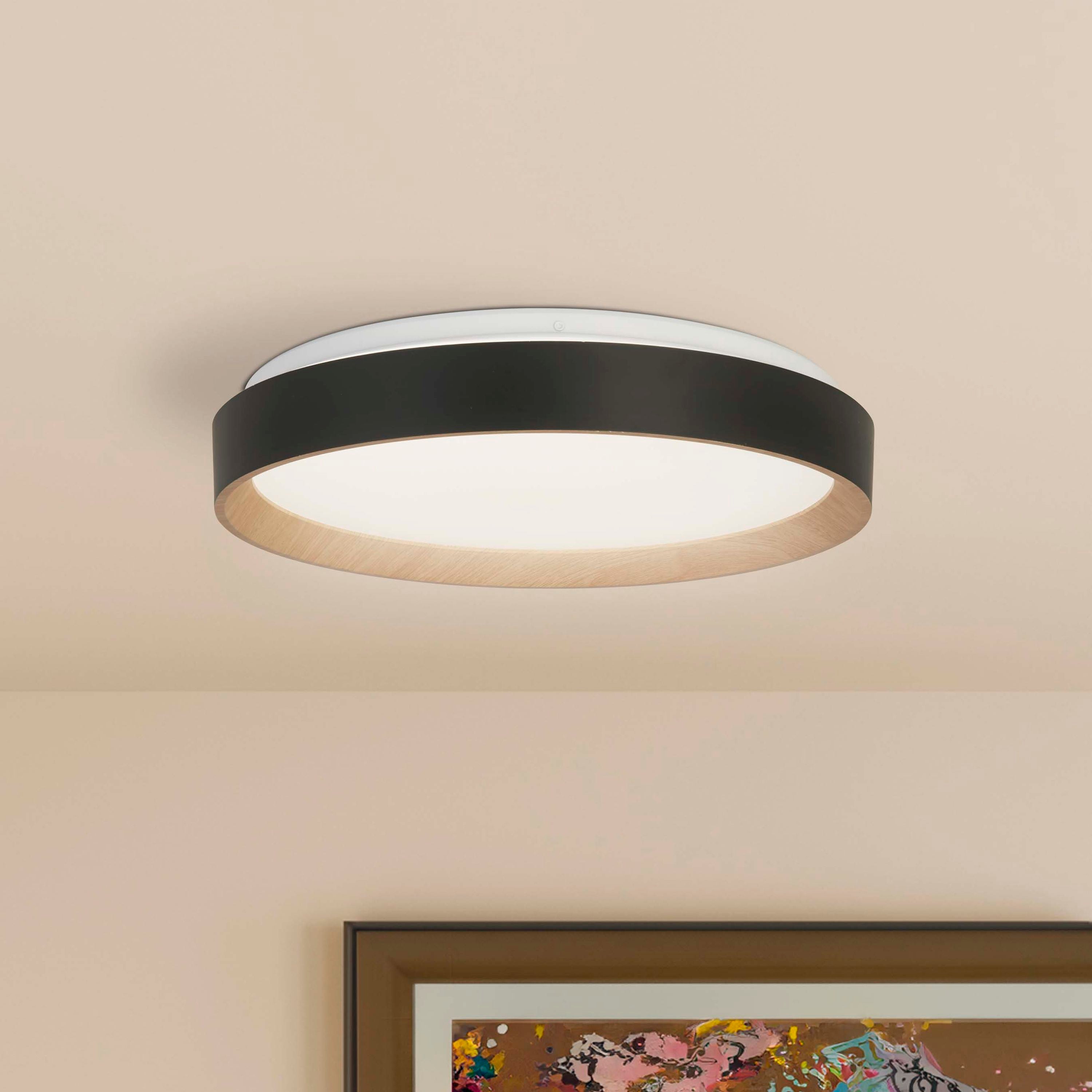 Searchlight Sorrento LED flush ceiling light installed on a ceiling above a framed abstract print in a pink toned room