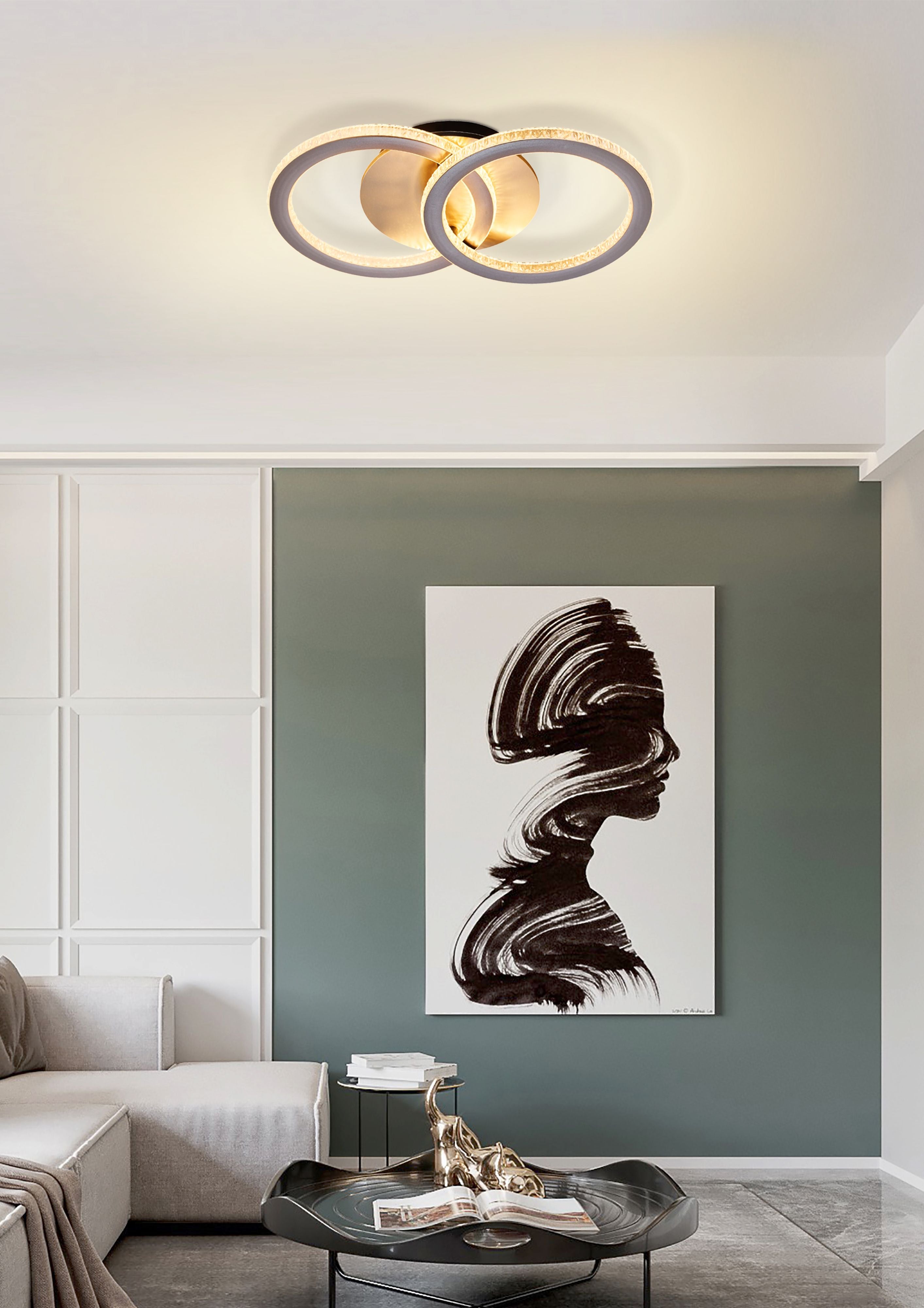 Searchlight Specs LED Flush Double Ring ceiling light in champagne metal, styled above a sofa and artwork in a modern living room with a sage green accent wall