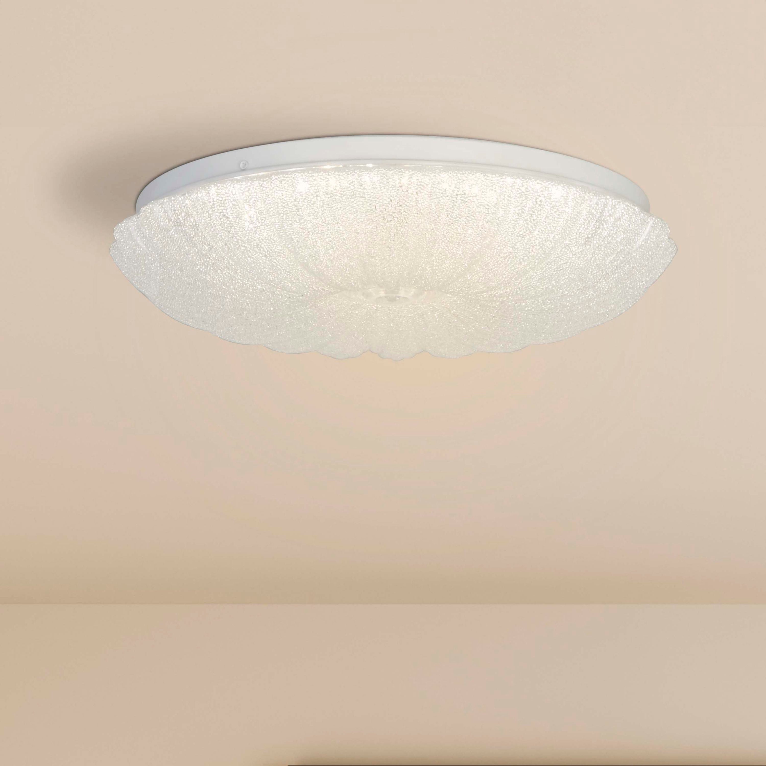 Searchlight Pandora LED flush ceiling light fitted to a ceiling in a styled room with a blush pink wall