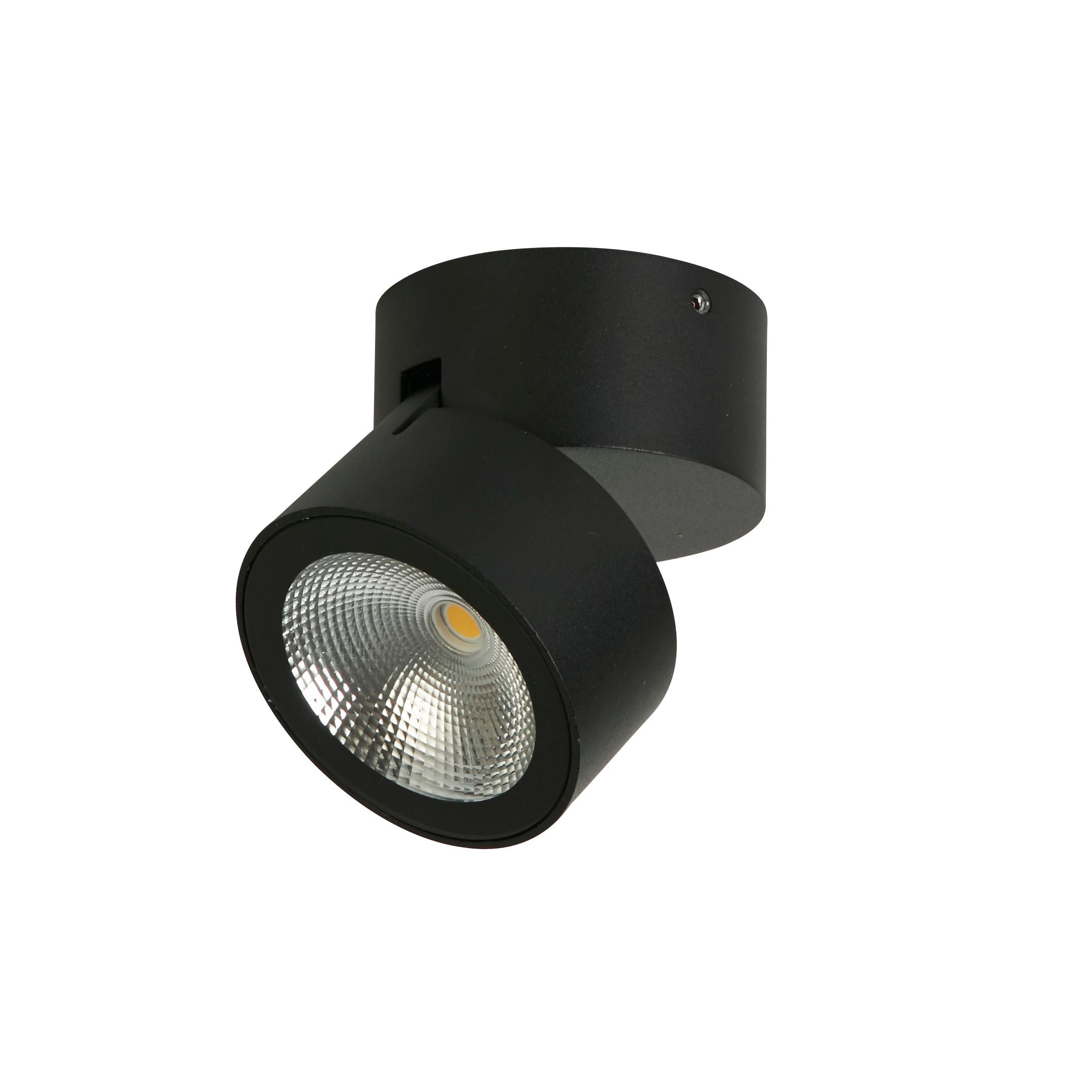 Searchlight Manhattan black adjustable spotlight on a white background, viewed from another angle showing the round base and pivoting head with warm LED glow