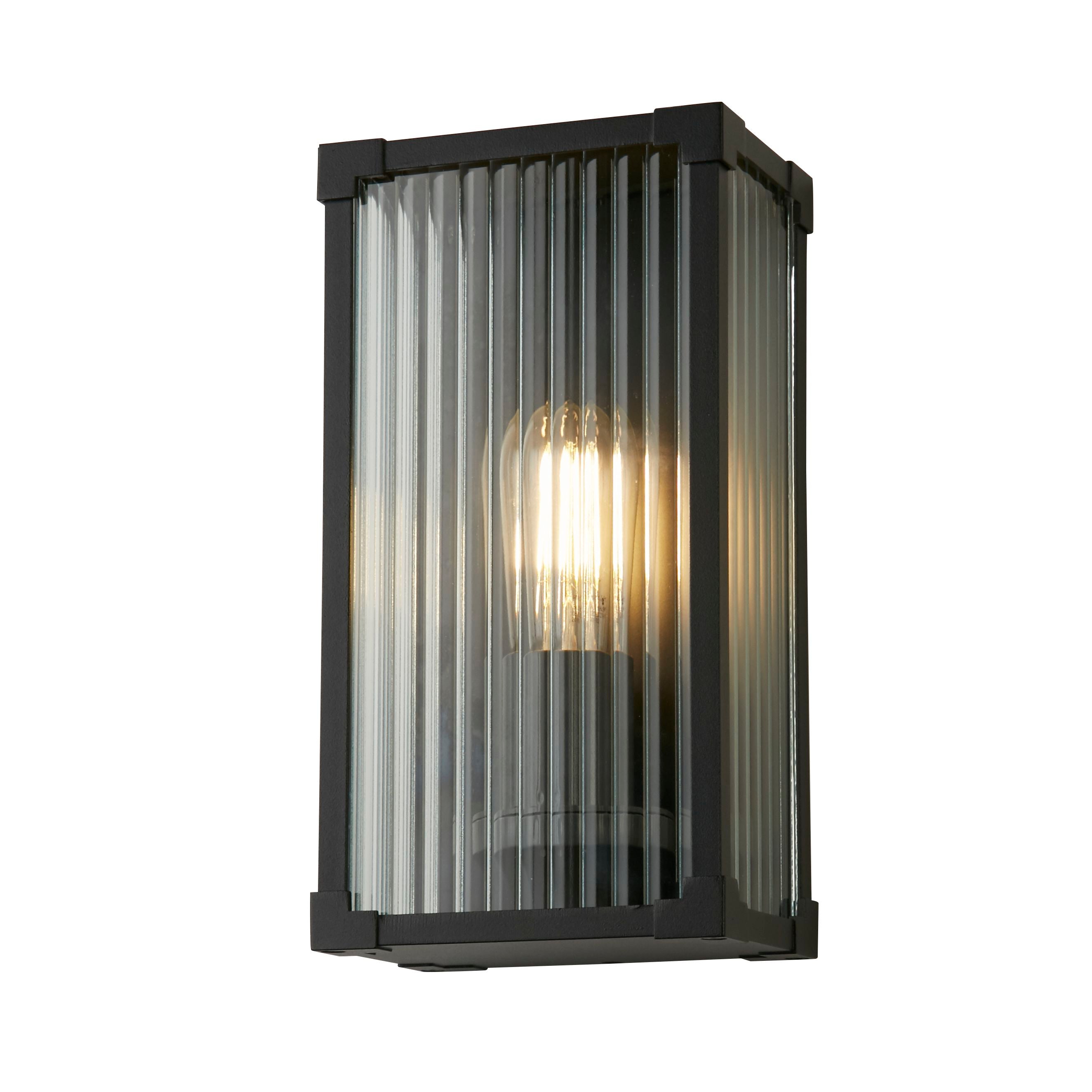 Searchlight Cincinnati outdoor wall light in matt black aluminium with clear ribbed glass, angled studio shot with bulb lit