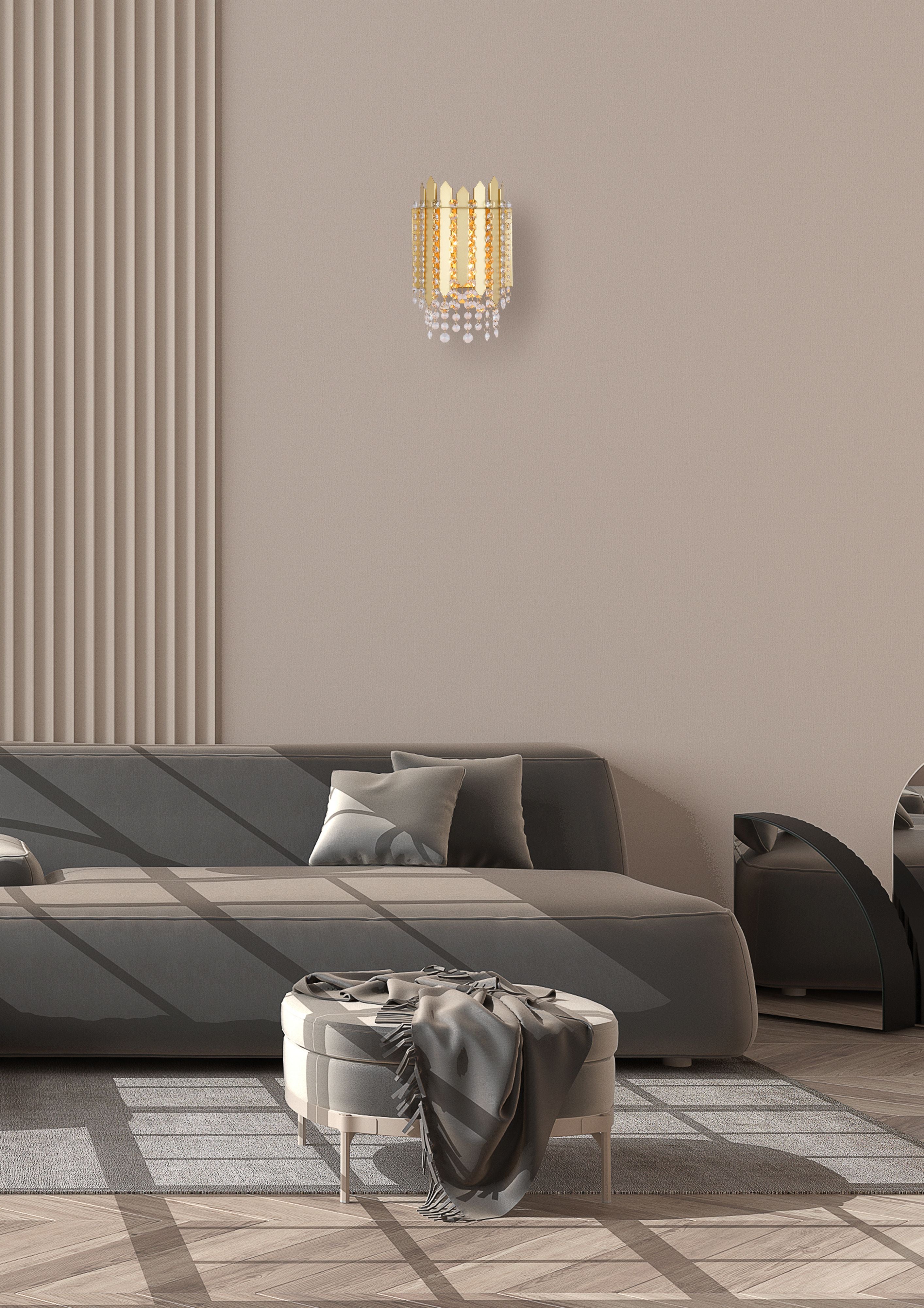 Searchlight Spear 2 Light Wall Light in gold with clear crystal, styled on a beige wall above a grey sofa in a modern living room