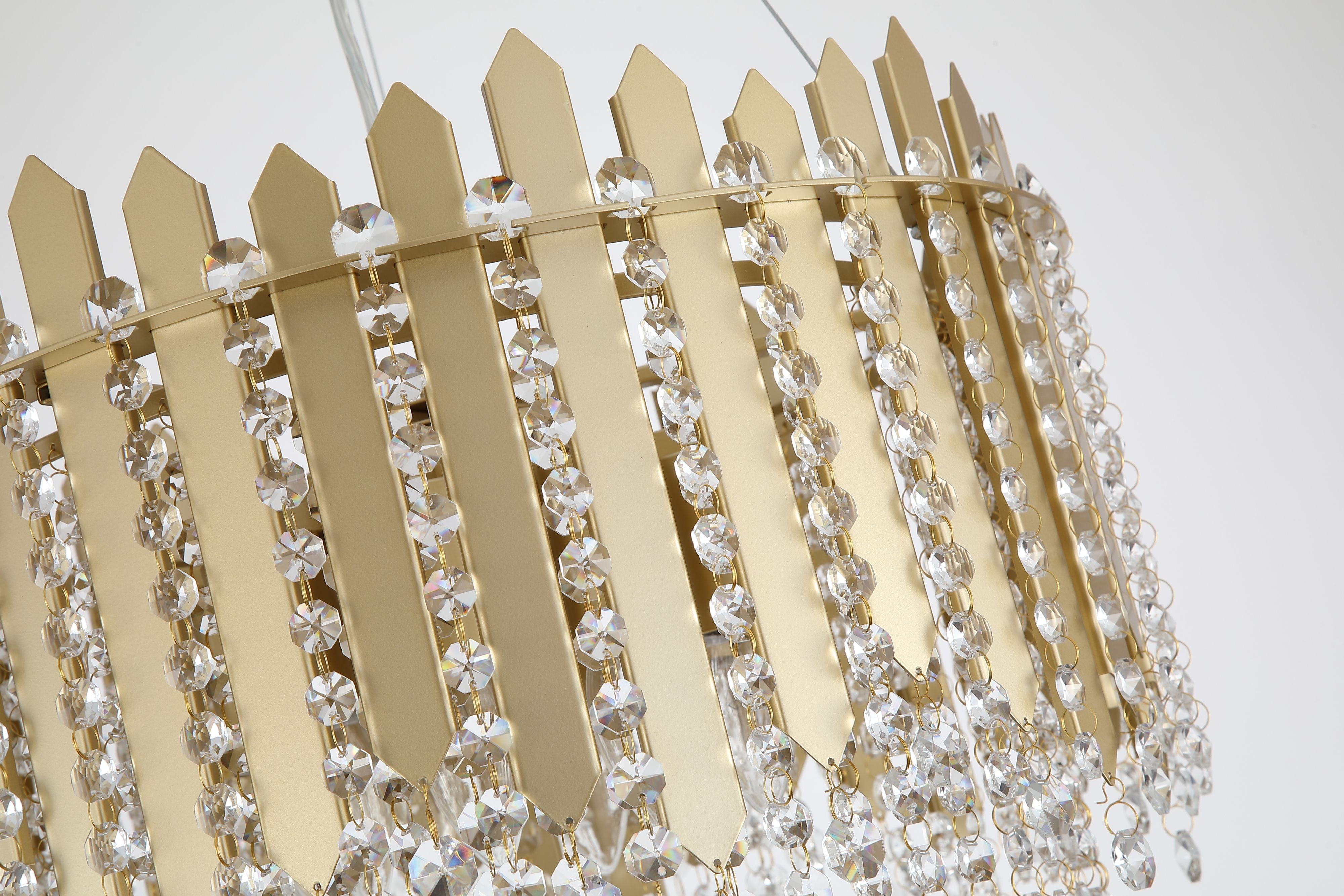 Close up angled view of the Searchlight Spear 8 Light Pendant showing the gold crown shaped panels and cascading crystal octagon beads, illuminated