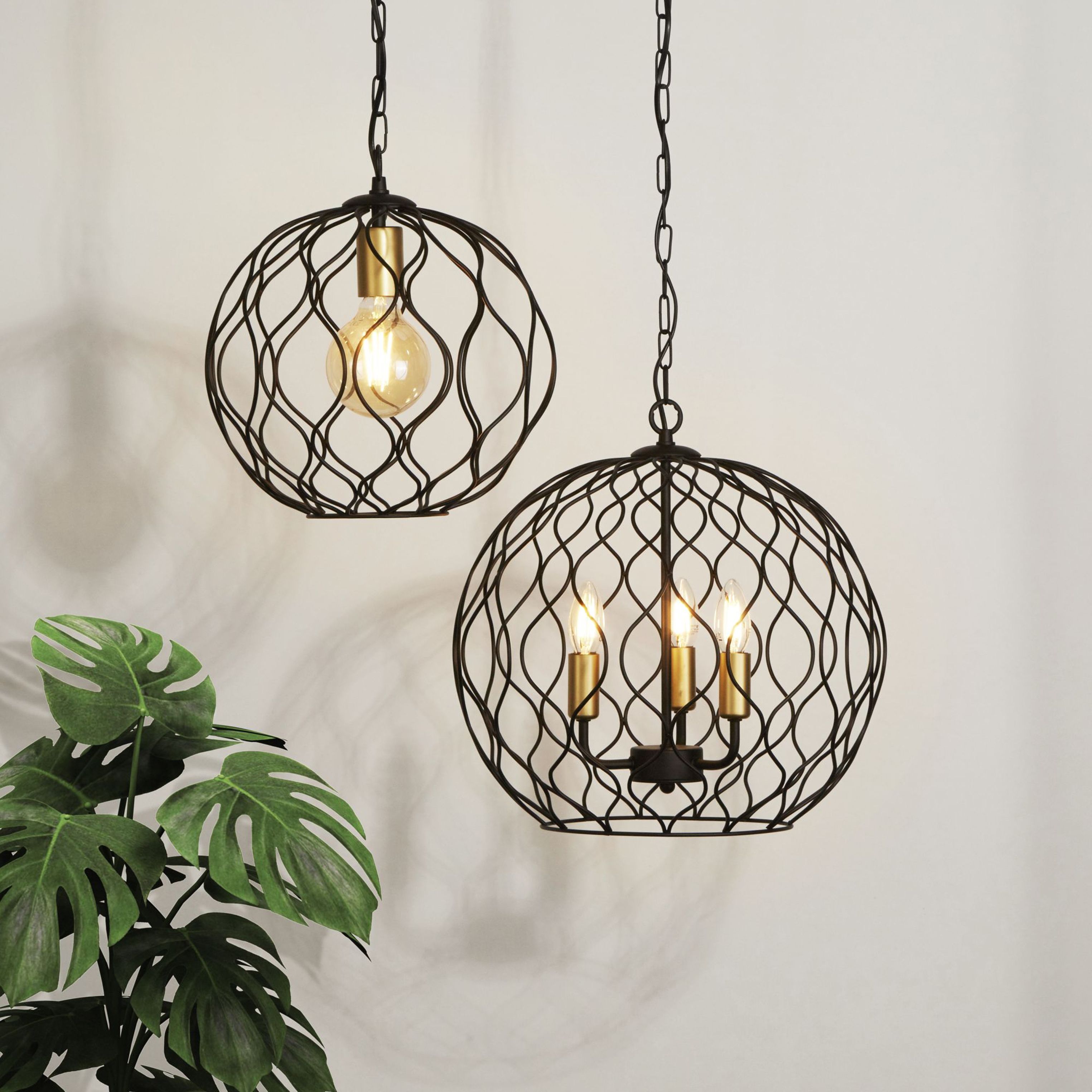 Searchlight Finesse pendant styled in a room beside a monstera plant, shown next to the three light version of the same wire lattice design for comparison