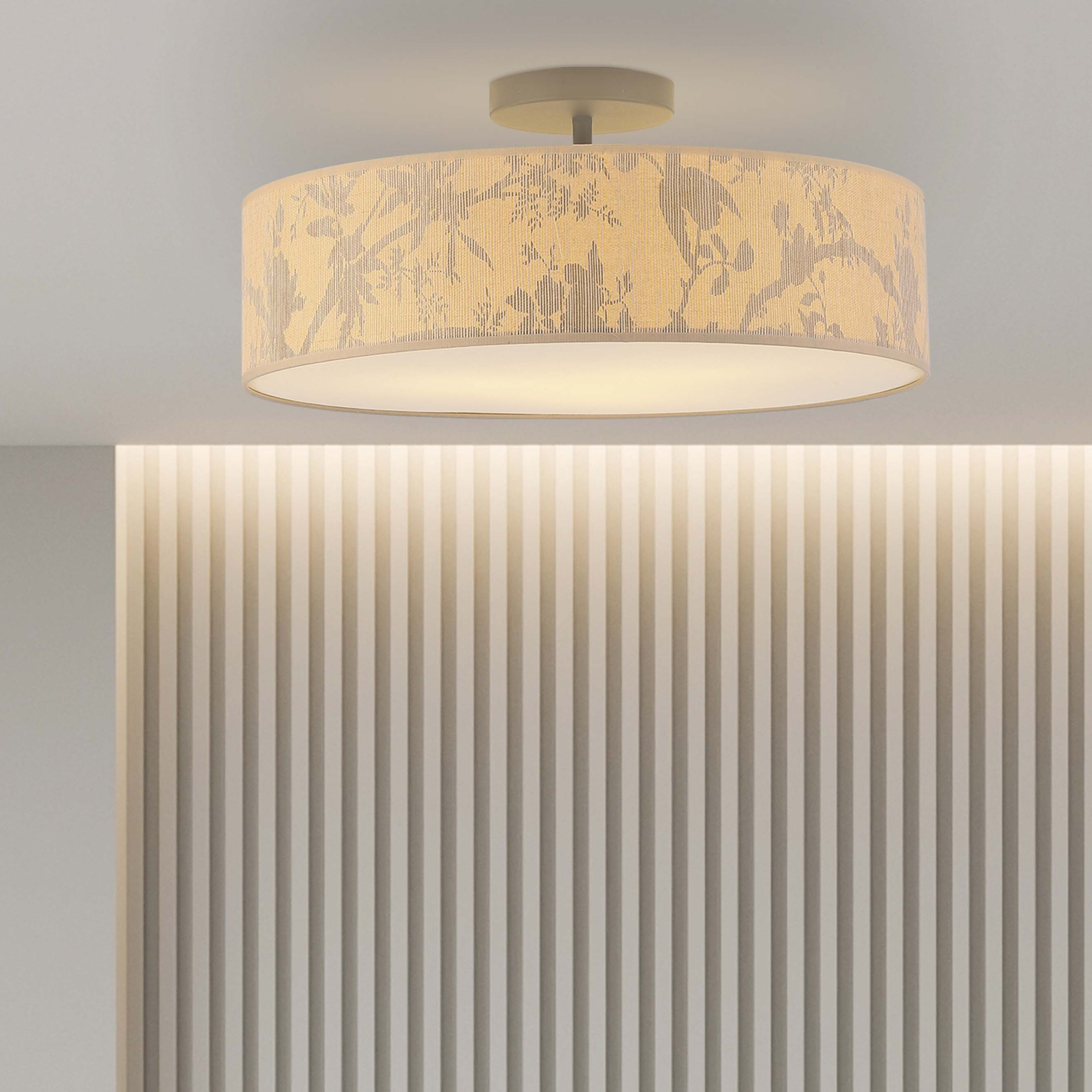 Isla 3 Light Flush ceiling light installed above a fluted wood panelled sideboard, glowing warmly in a styled living room setting