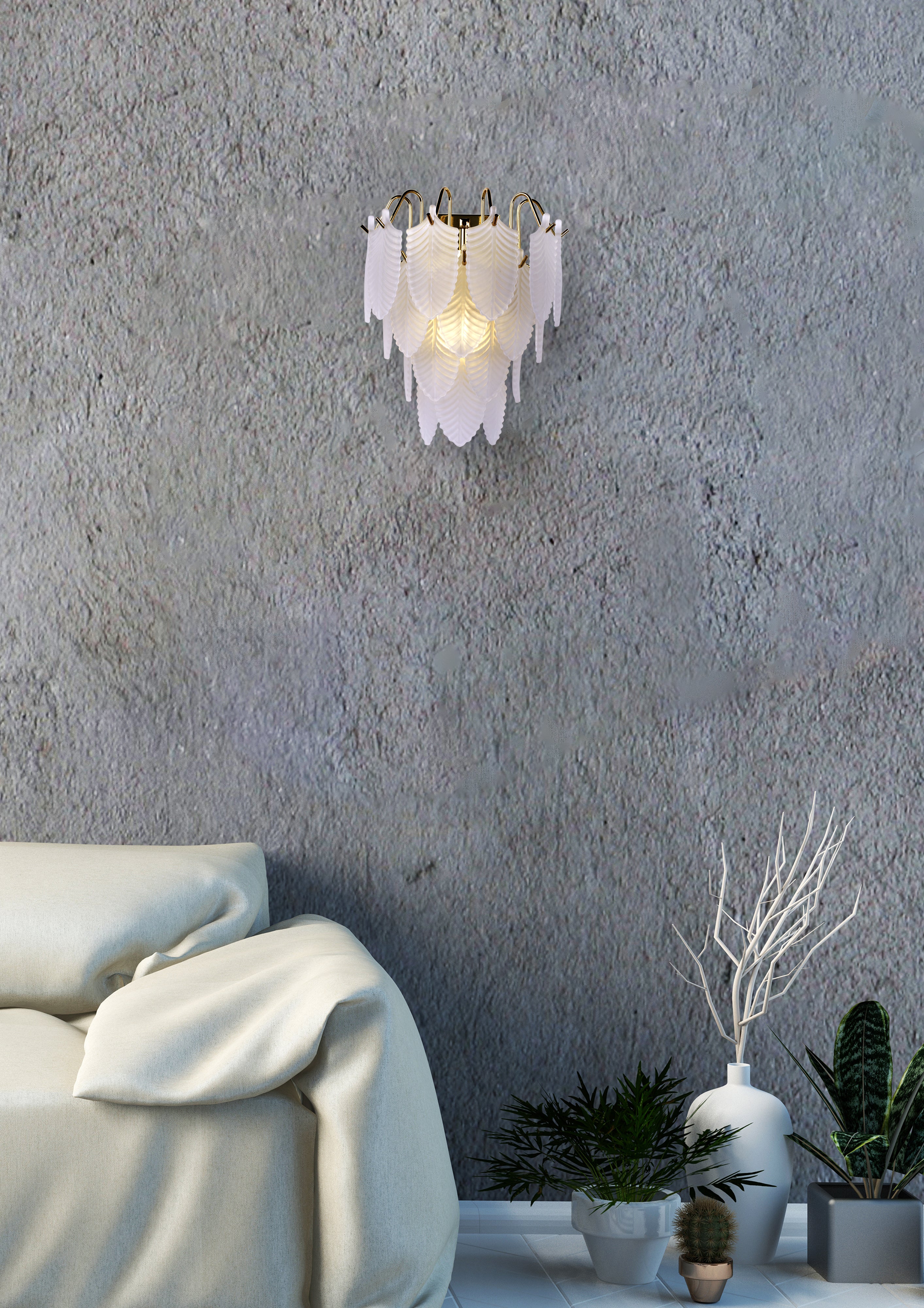 Searchlight Feather wall light in polished brass, lit and mounted on a grey textured wall above a cream sofa with potted plants nearby