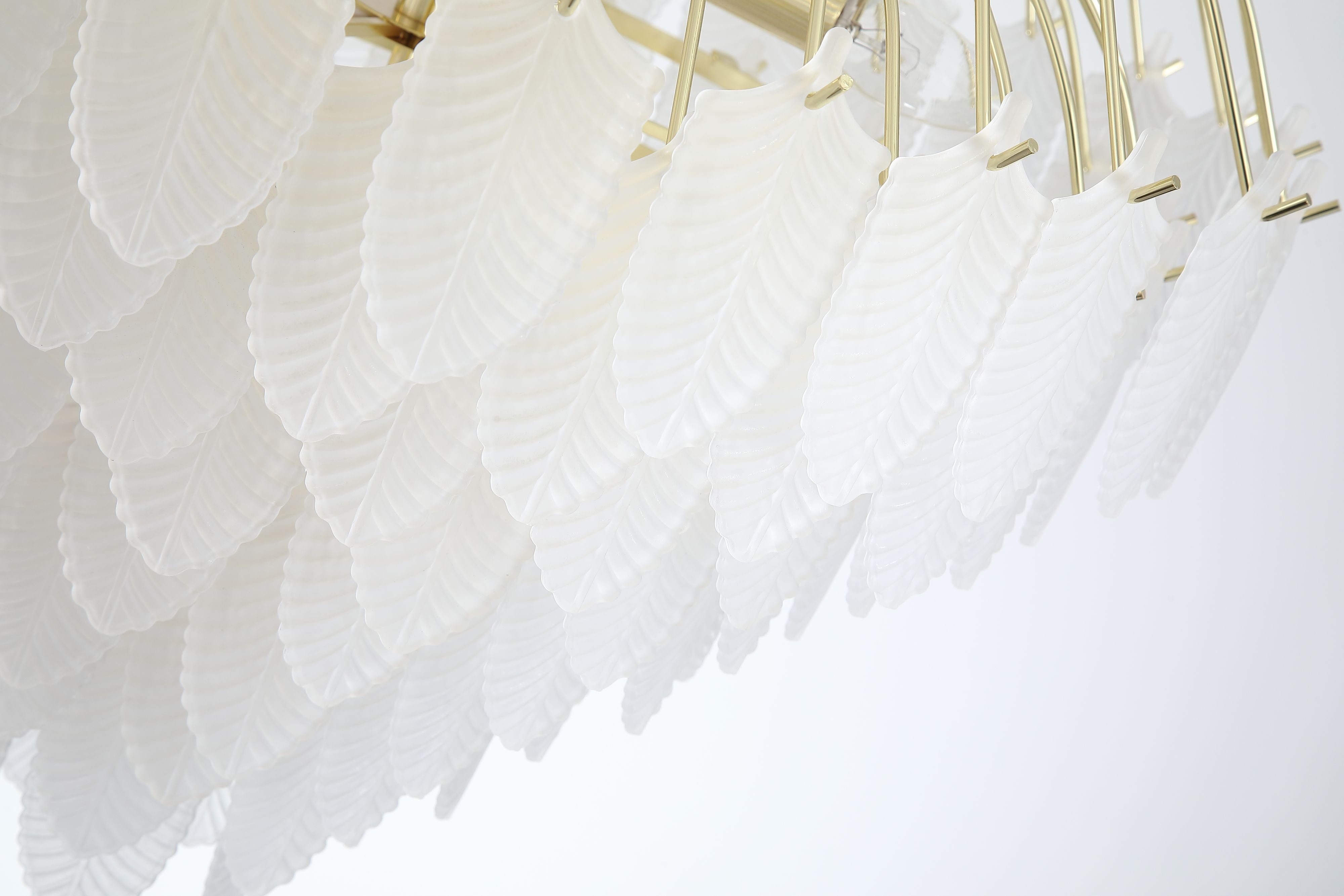 Searchlight Feather 6 light pendant in polished brass, close up angled view of the frosted glass feather shades and brass fittings