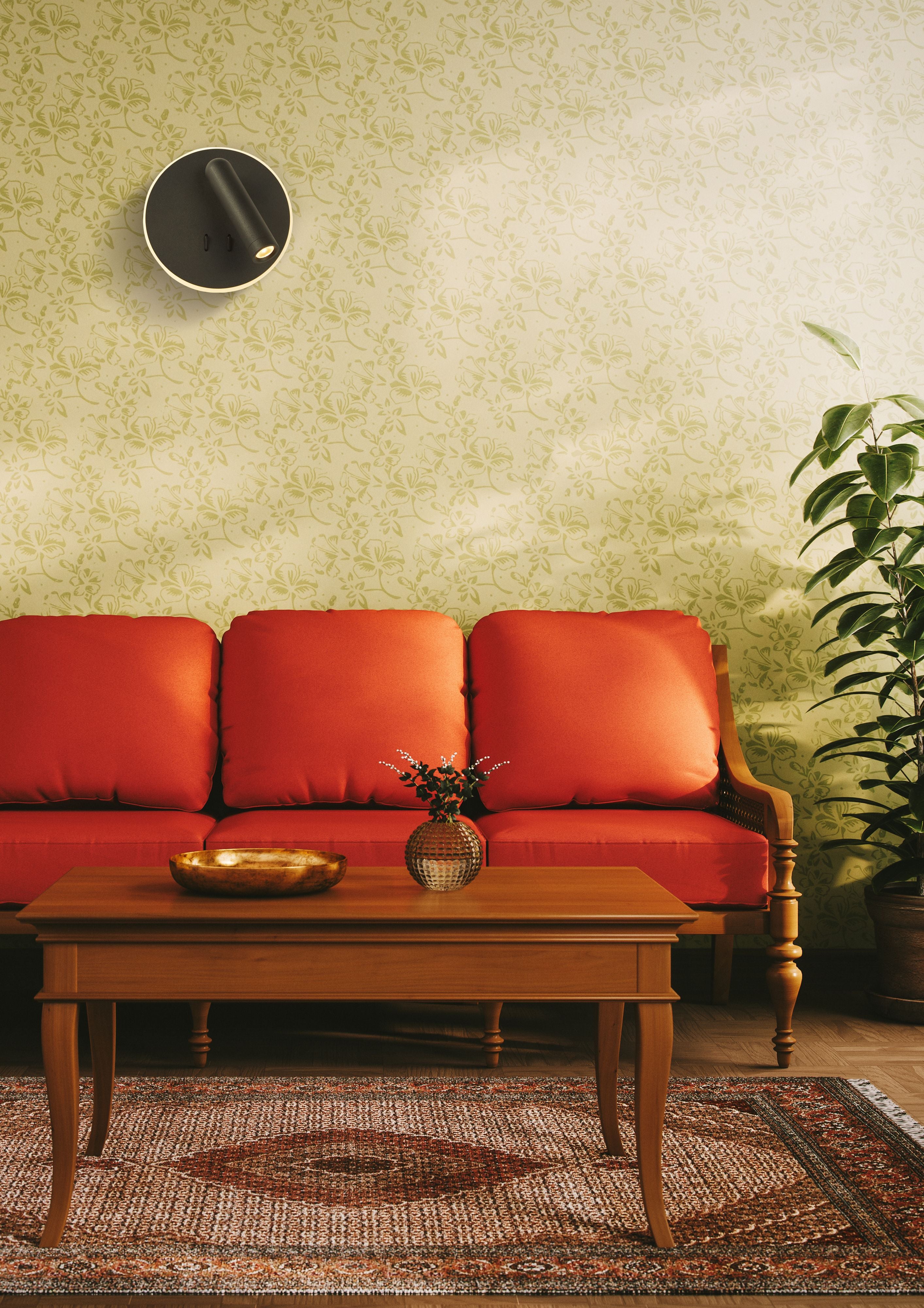Cher LED wall light in black mounted above a red sofa in a living room with green floral wallpaper, spotlight switched on
