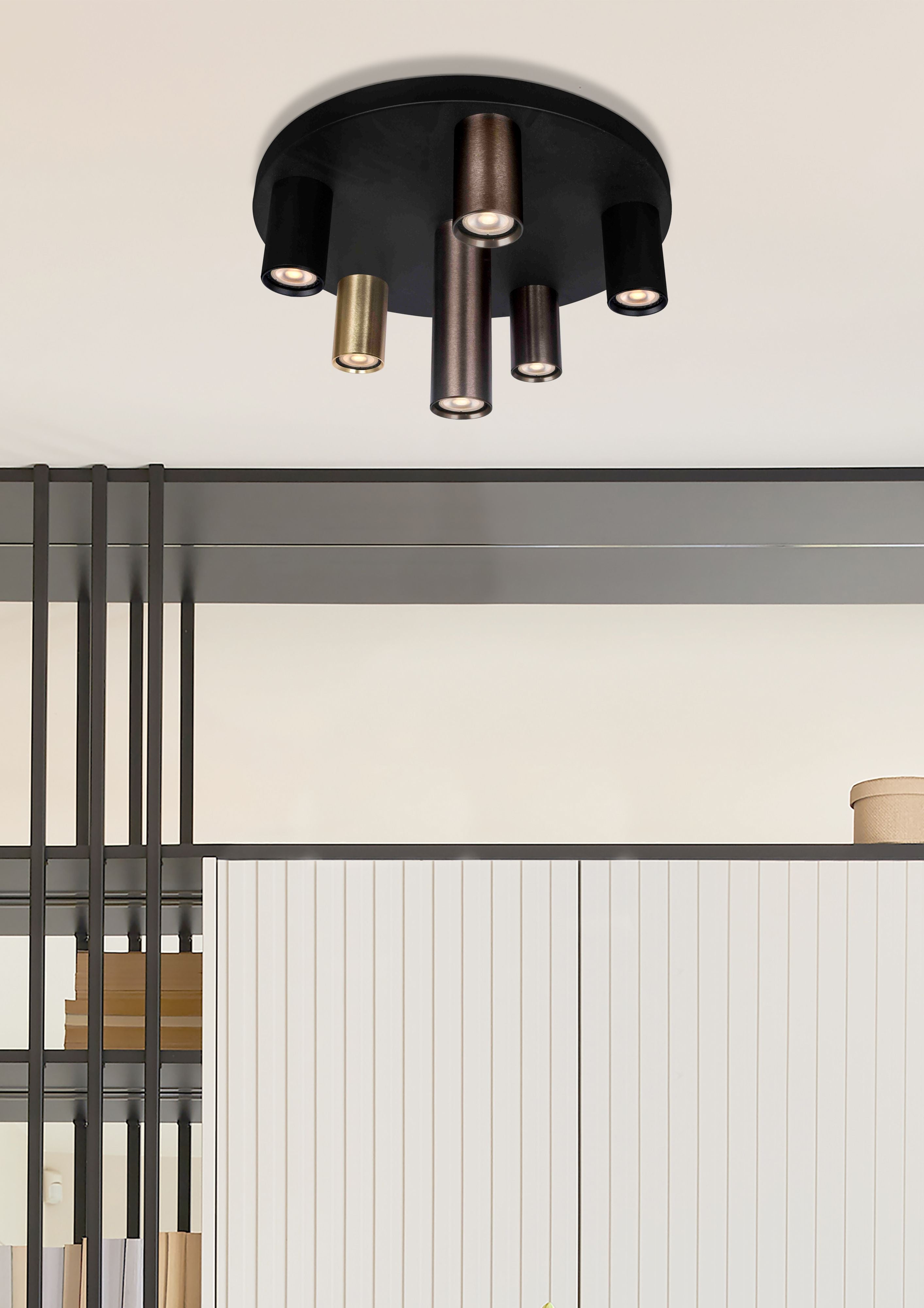 Searchlight Tubes 6 Light Flush 40cm installed on a ceiling in a neutral toned room with open shelving, books and a mirror below, tubes lit with a warm glow