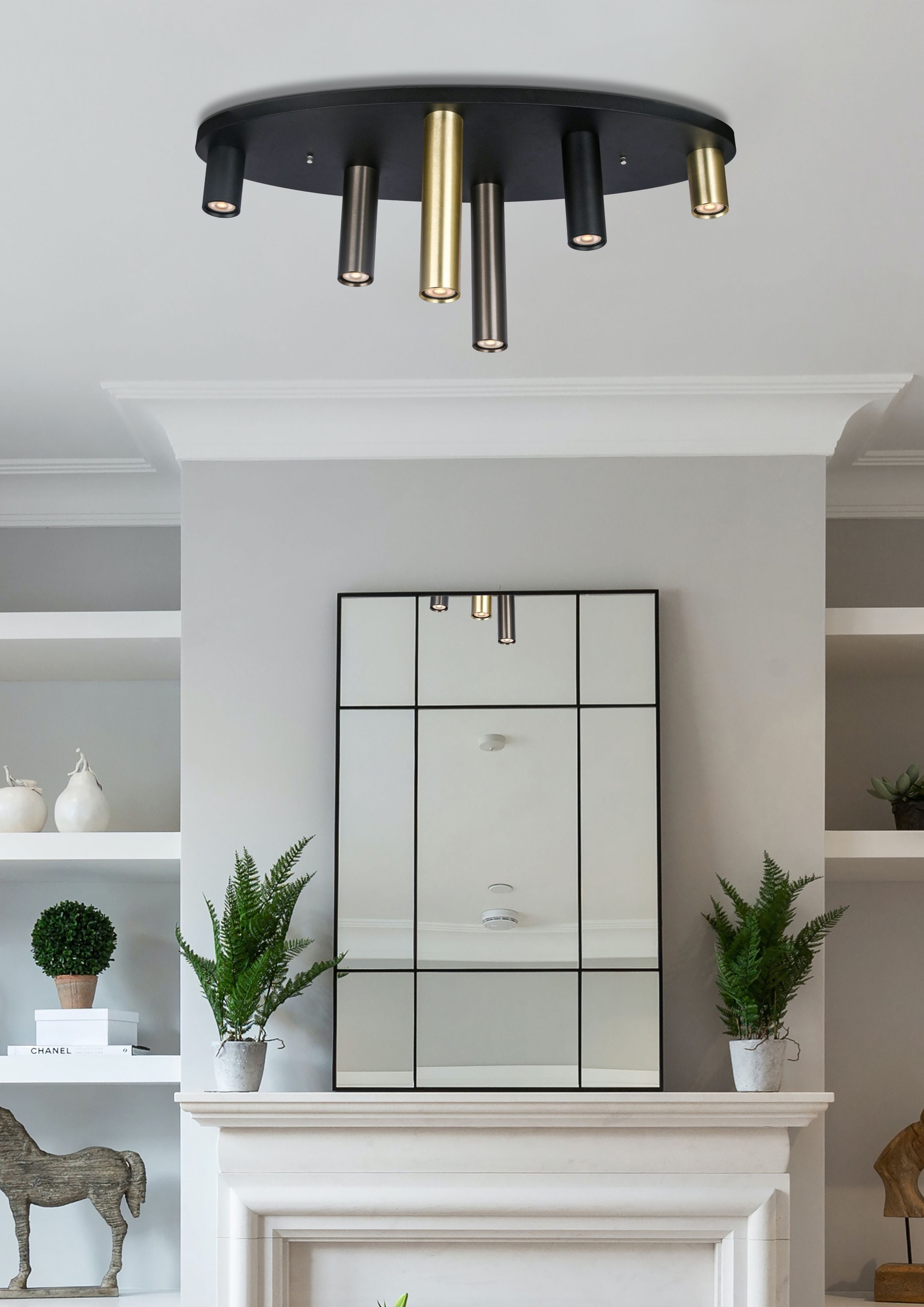 Searchlight Tubes 6 Light Flush 80cm installed on a ceiling above a mantelpiece with a mirror, potted ferns and ornaments, tubes lit with a warm glow