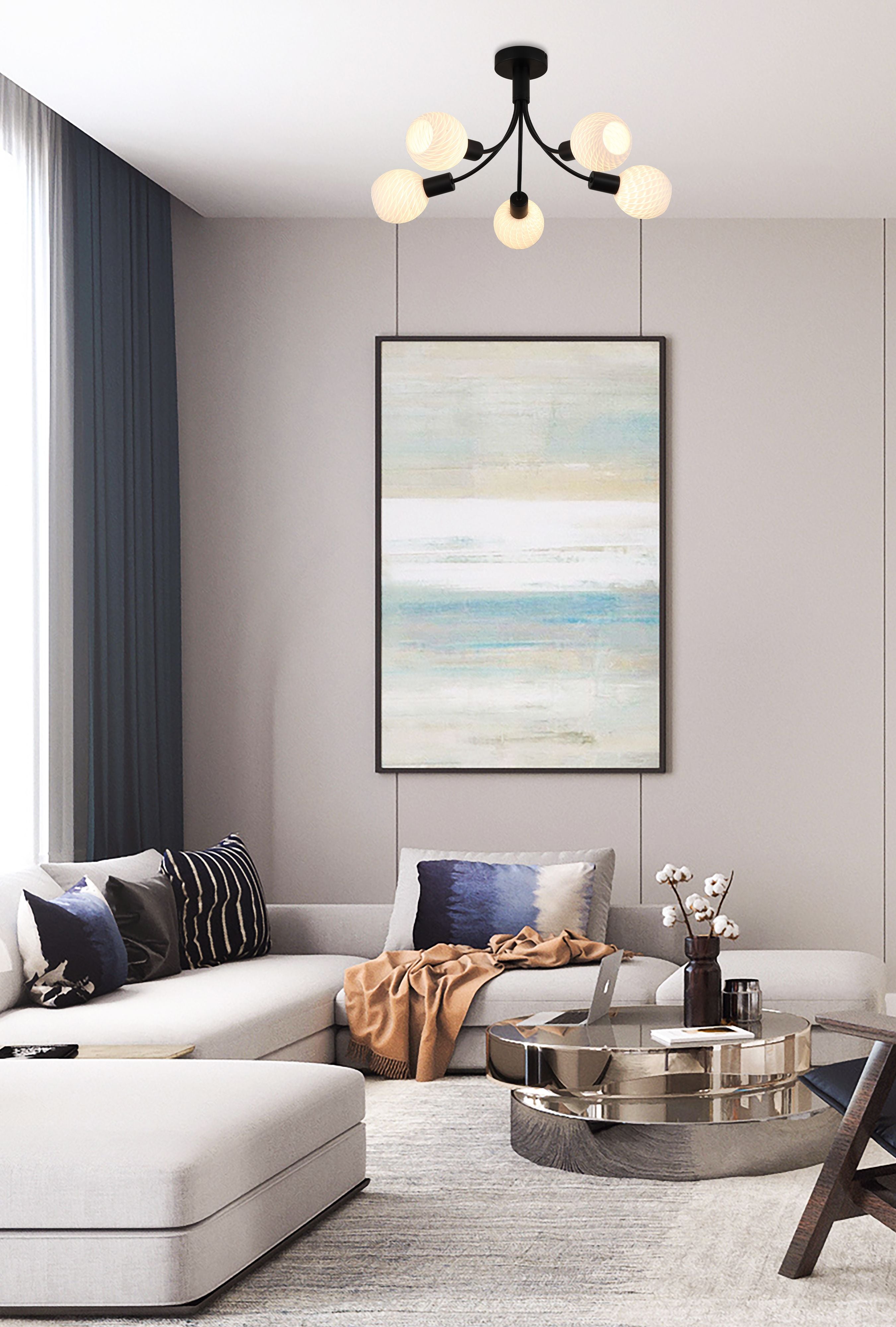 Searchlight Nova 5 light ceiling lamp styled in a modern living room above a grey sofa, ottoman and round coffee table with framed abstract wall art