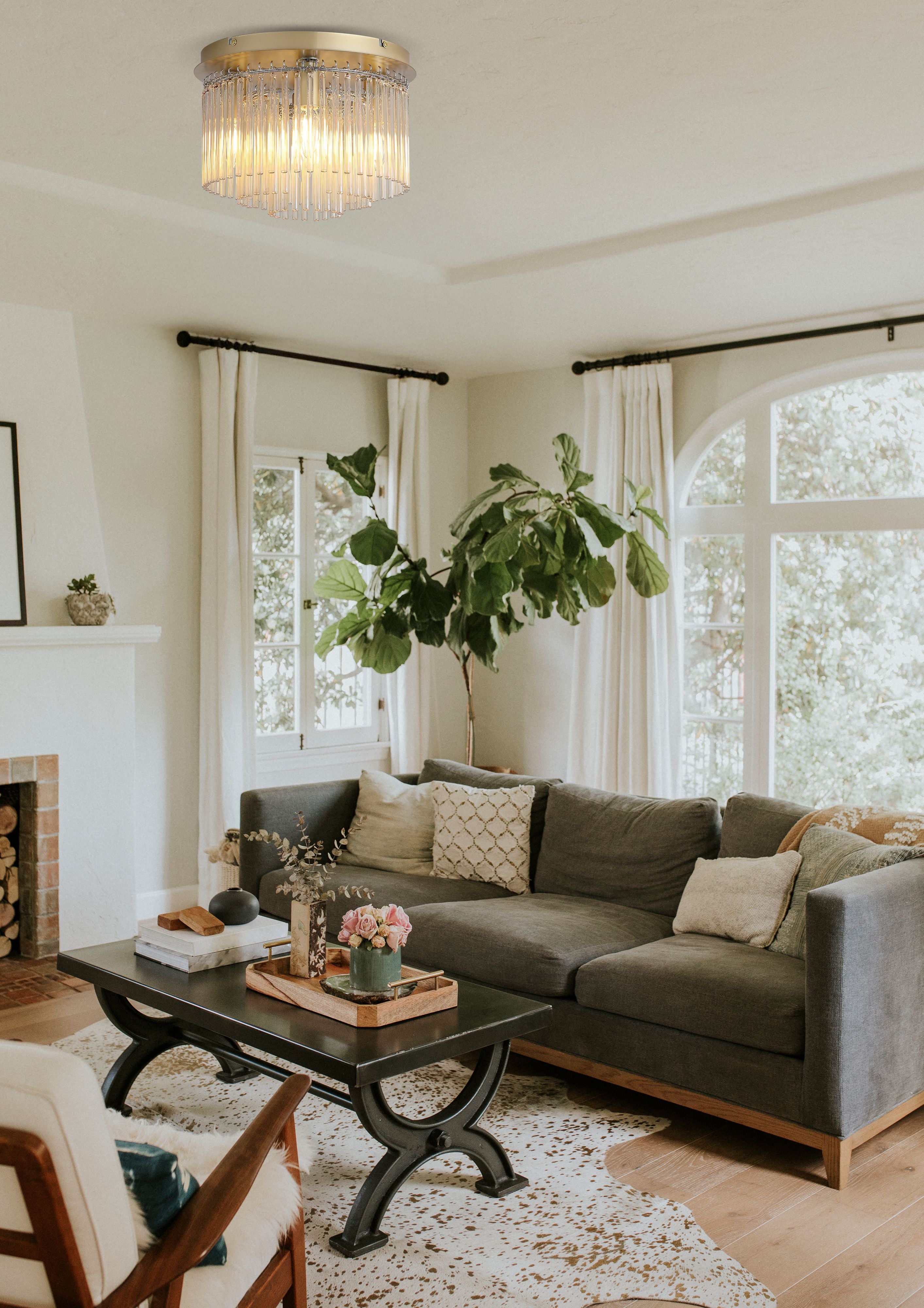 Searchlight Swizzle 5 light flush in gold styled on the ceiling of a bright living room with a fireplace and grey sofa