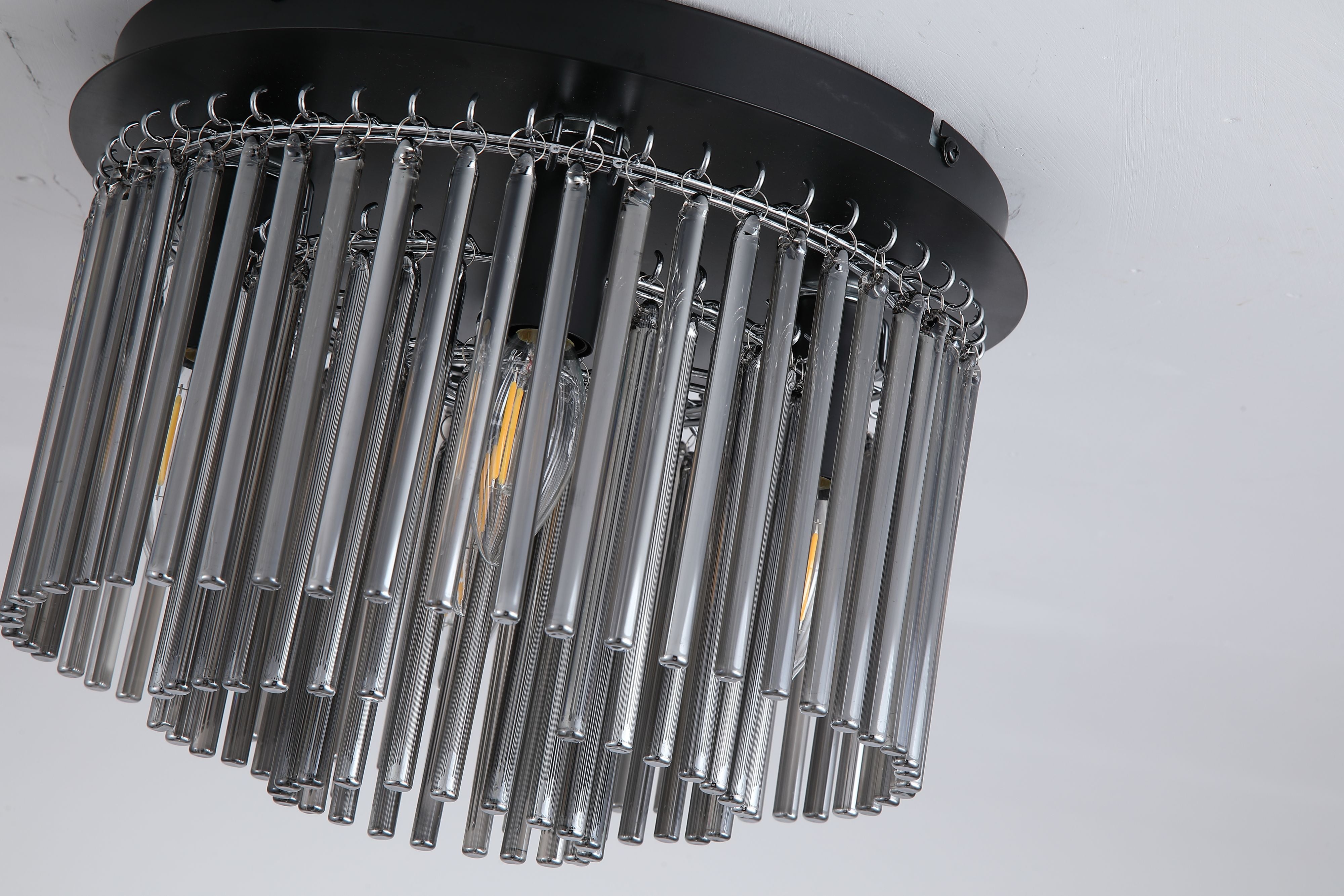 Close up angled view of the Searchlight Swizzle 5 Light Flush showing the smoked glass rod detail and lit candle bulbs