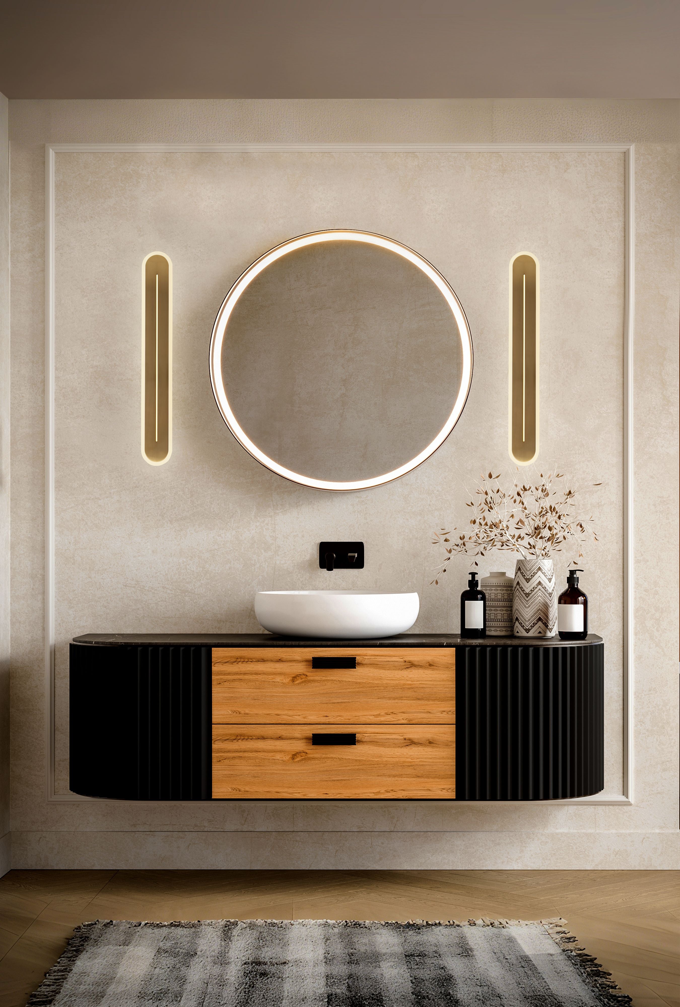 Pair of Couper LED wall lights in satin brass mounted either side of a round mirror above a black and oak bathroom vanity