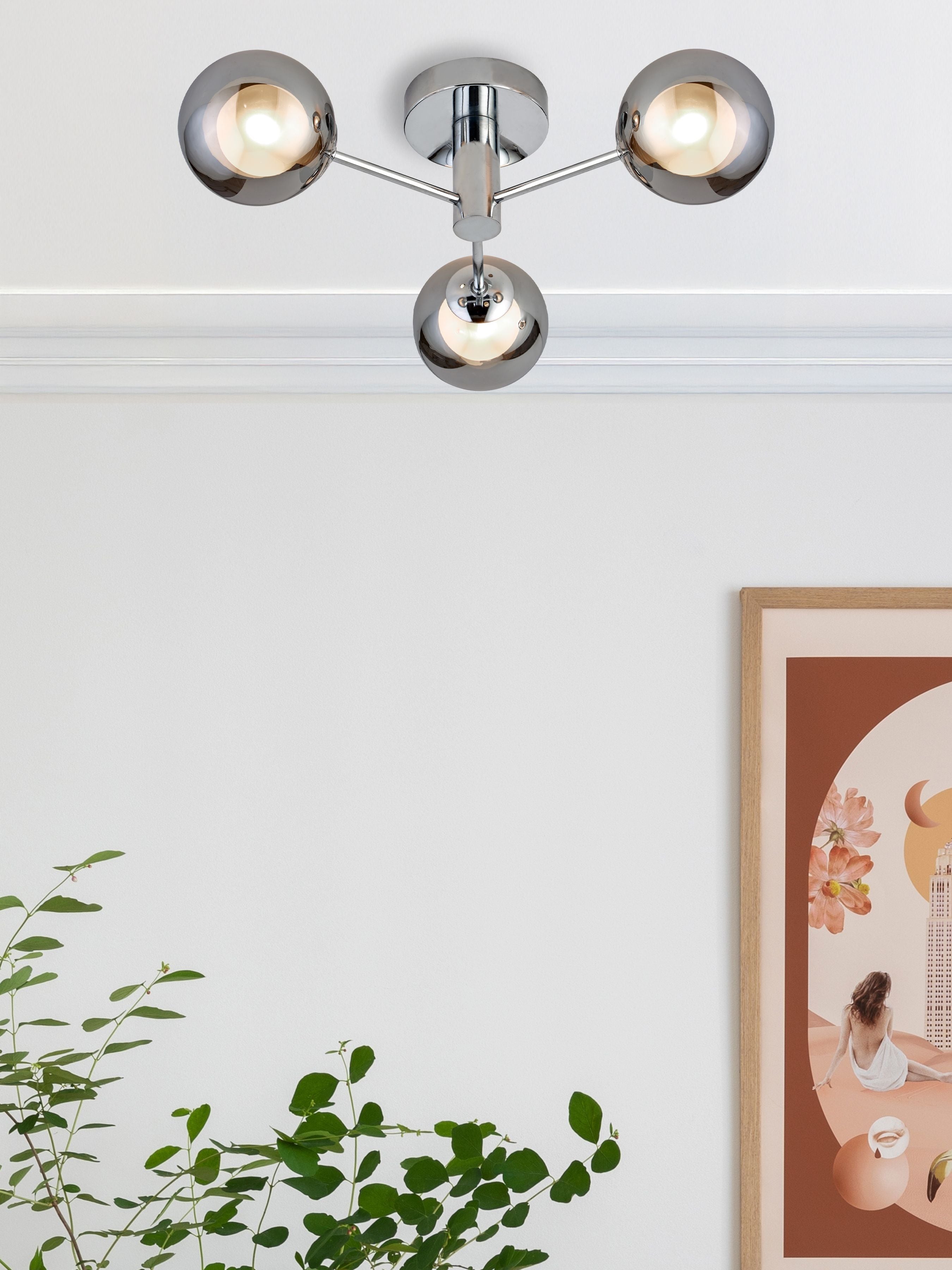 Searchlight Oscar 3 Light Flush in chrome and smoked glass styled on a ceiling near a framed print and a house plant