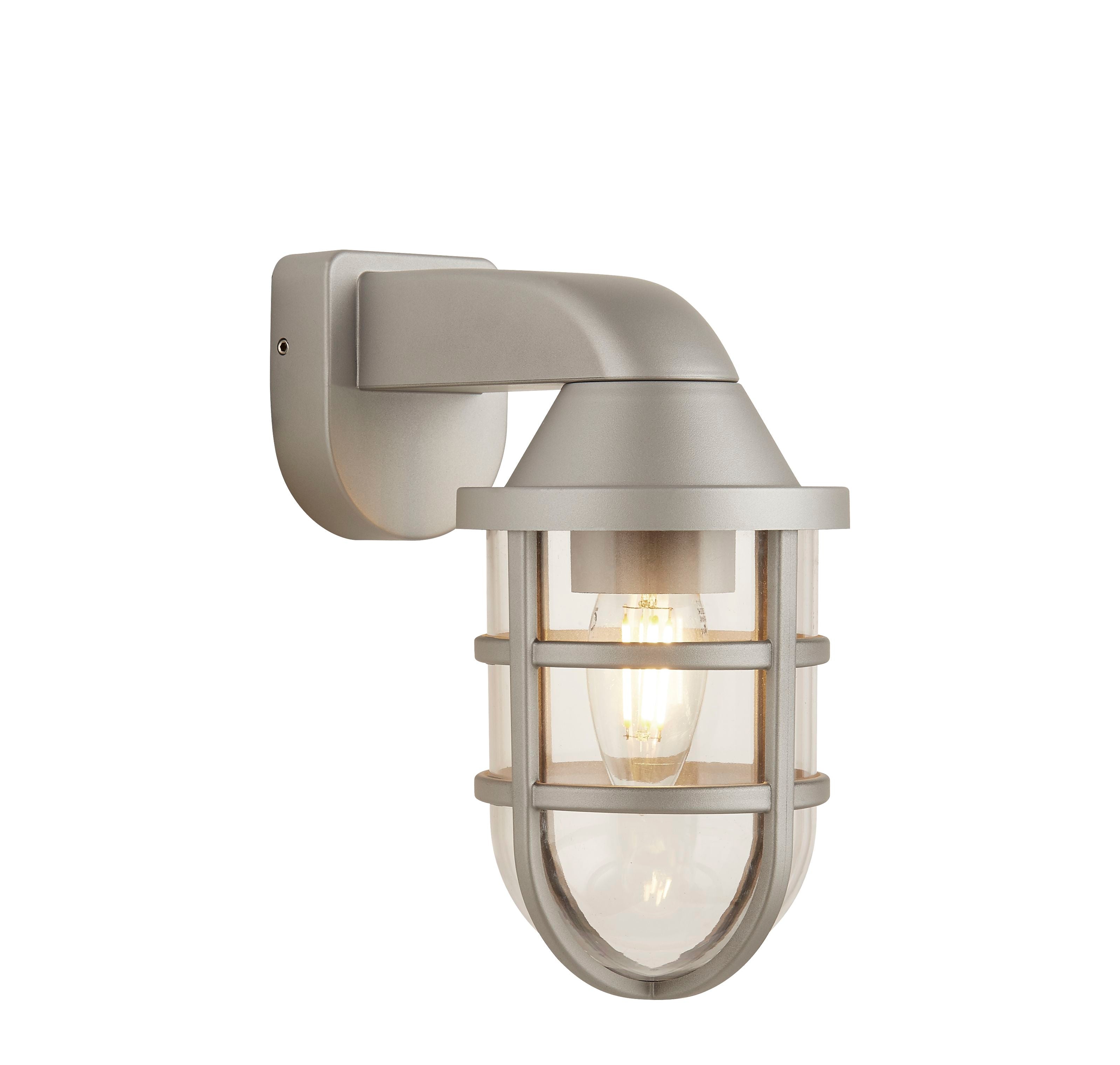 Searchlight Seaside silver ships lantern wall light with angled arm bracket and caged glass shade, studio view with the bulb lit
